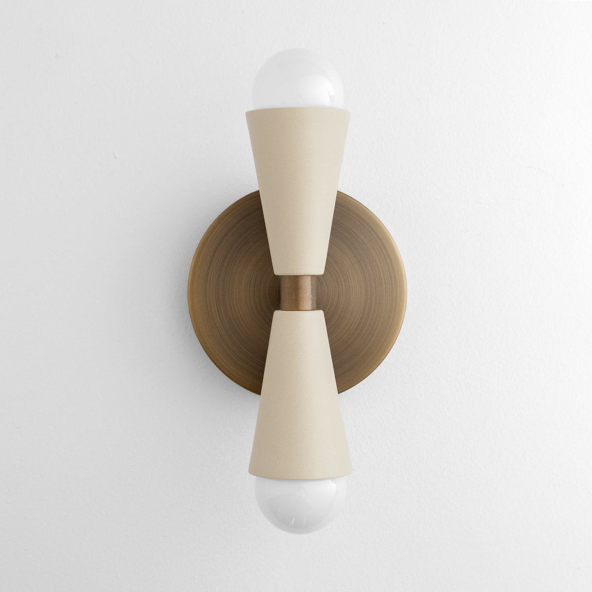 Antique brass wall sconce with cream tapered metal shades and exposed bulbs top and bottom. - SCONCE MODEL NO. 4717