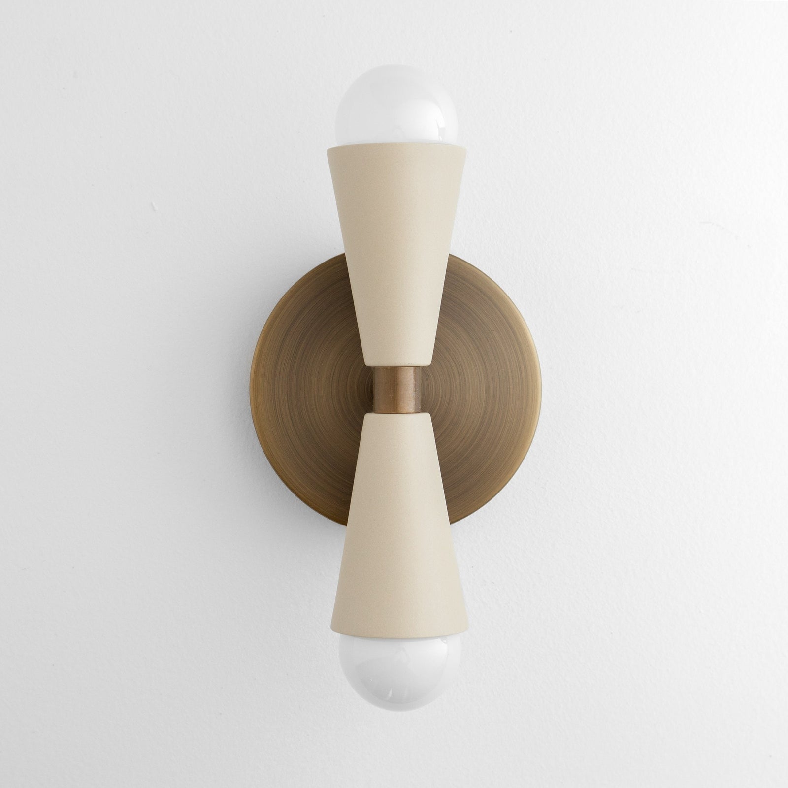 Antique brass wall sconce with cream tapered metal shades and exposed bulbs top and bottom. - SCONCE MODEL NO. 4717
