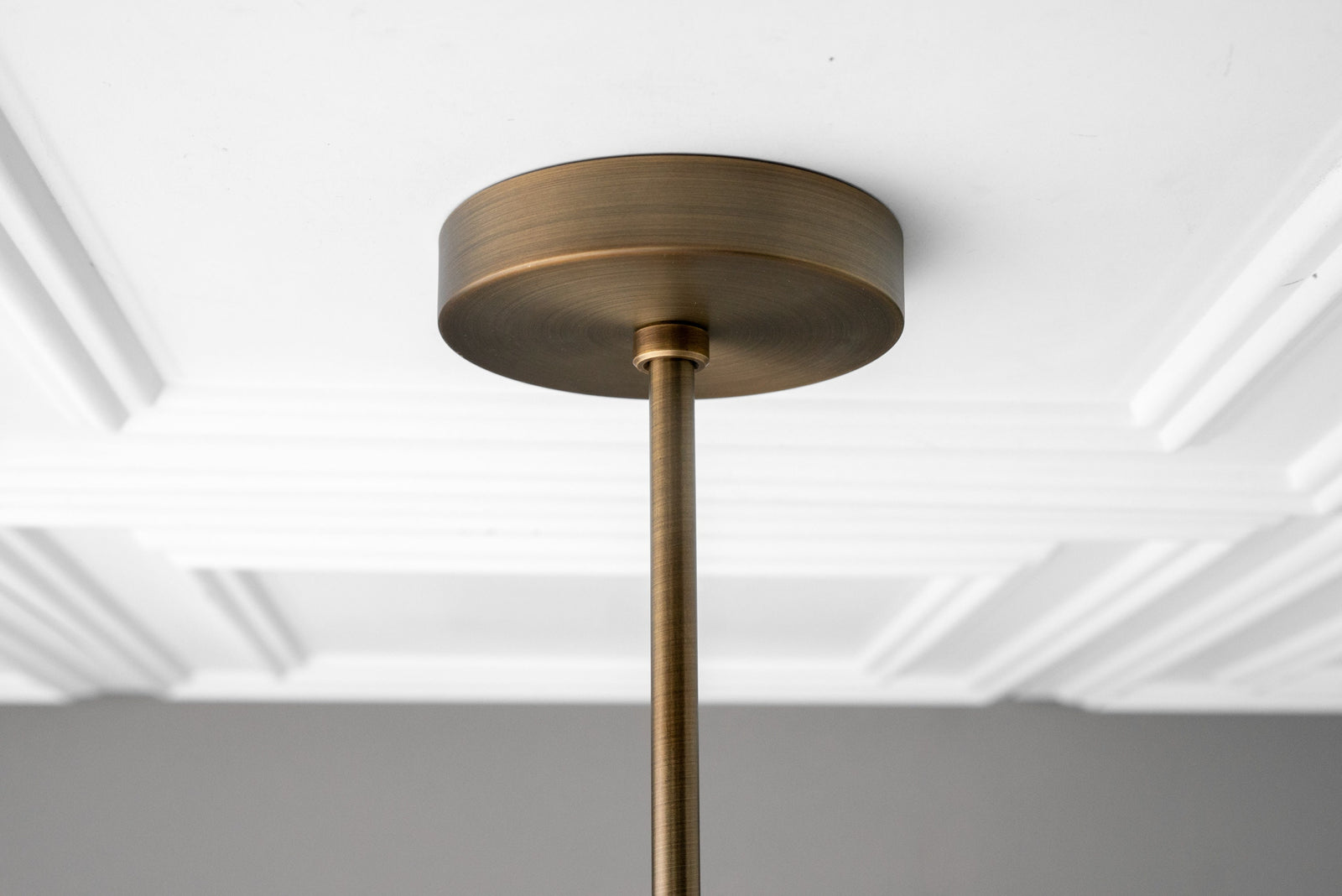 Antique brass ceiling mount with rod from industrial linear chandelier, close-up view. - CHANDELIER MODEL NO. 4577