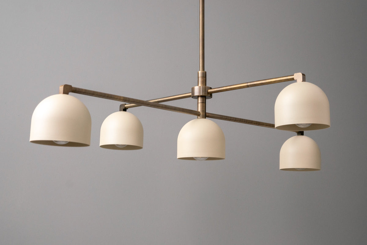 Industrial chandelier with five cream dome shades and an antique brass swivel frame. - CHANDELIER MODEL NO. 8133