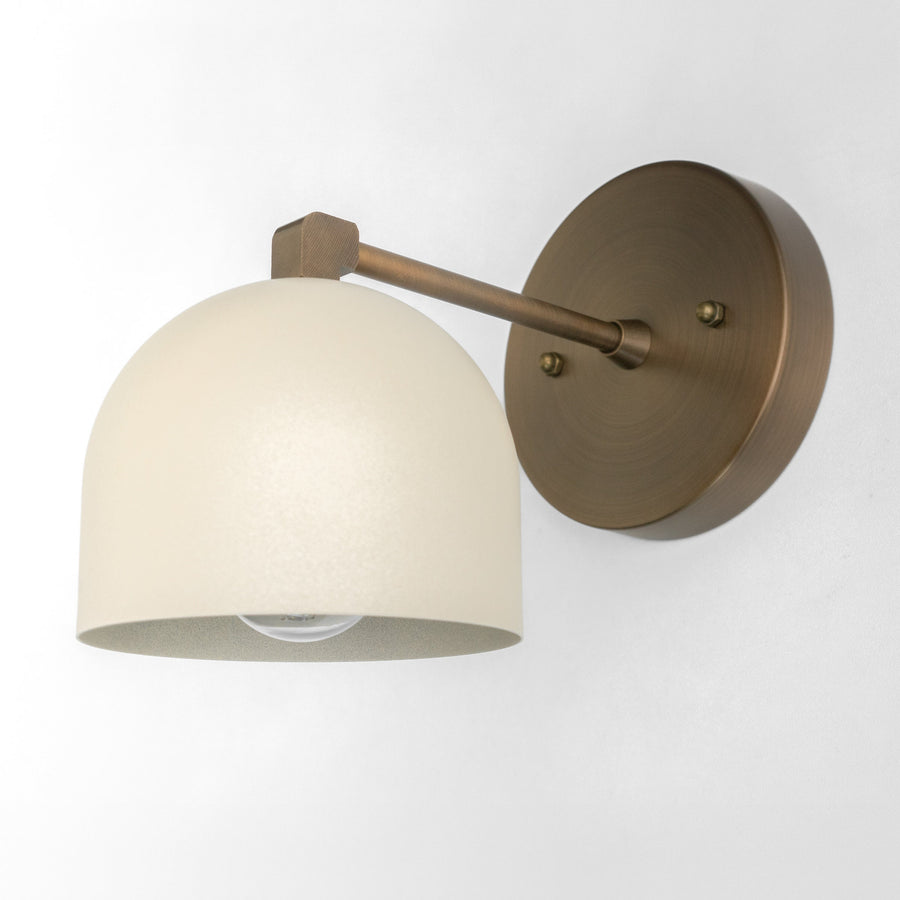 Antique brass wall sconce with cream dome-shaped glass shade and minimalist arm design. - SCONCE MODEL NO. 8704