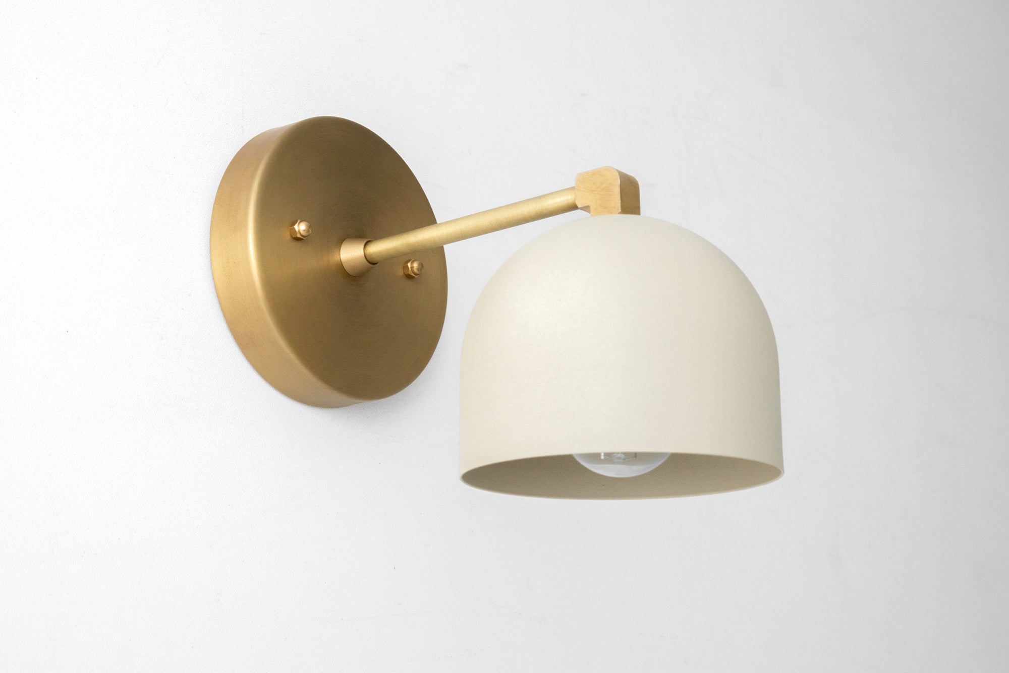 Wall sconce with cream dome shade and brushed brass arm and round backplate. - SCONCE MODEL NO. 8704
