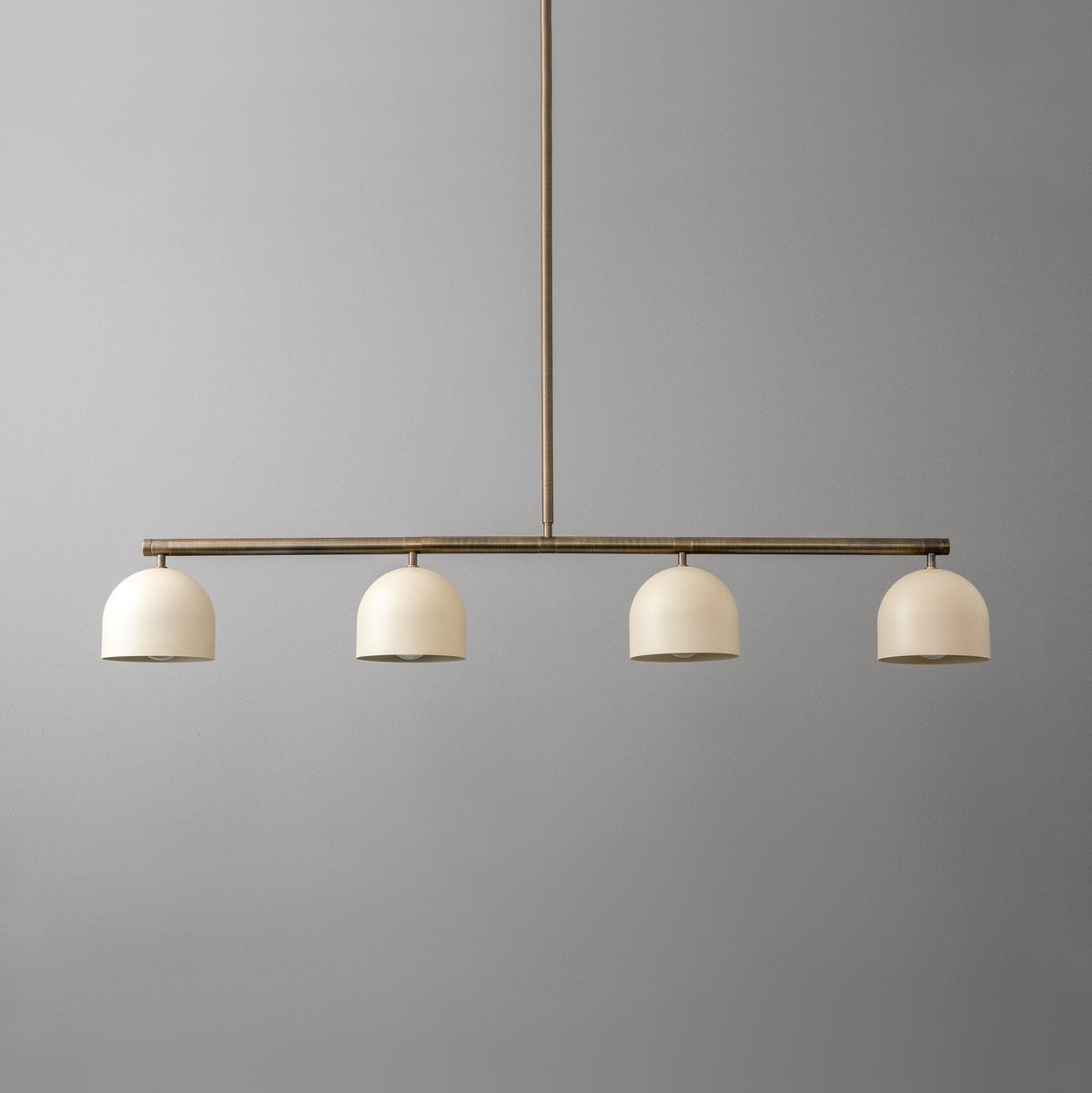 Linear chandelier with four matte white globe shades and antique brass finish rod. - CHANDELIER MODEL NO. 7998