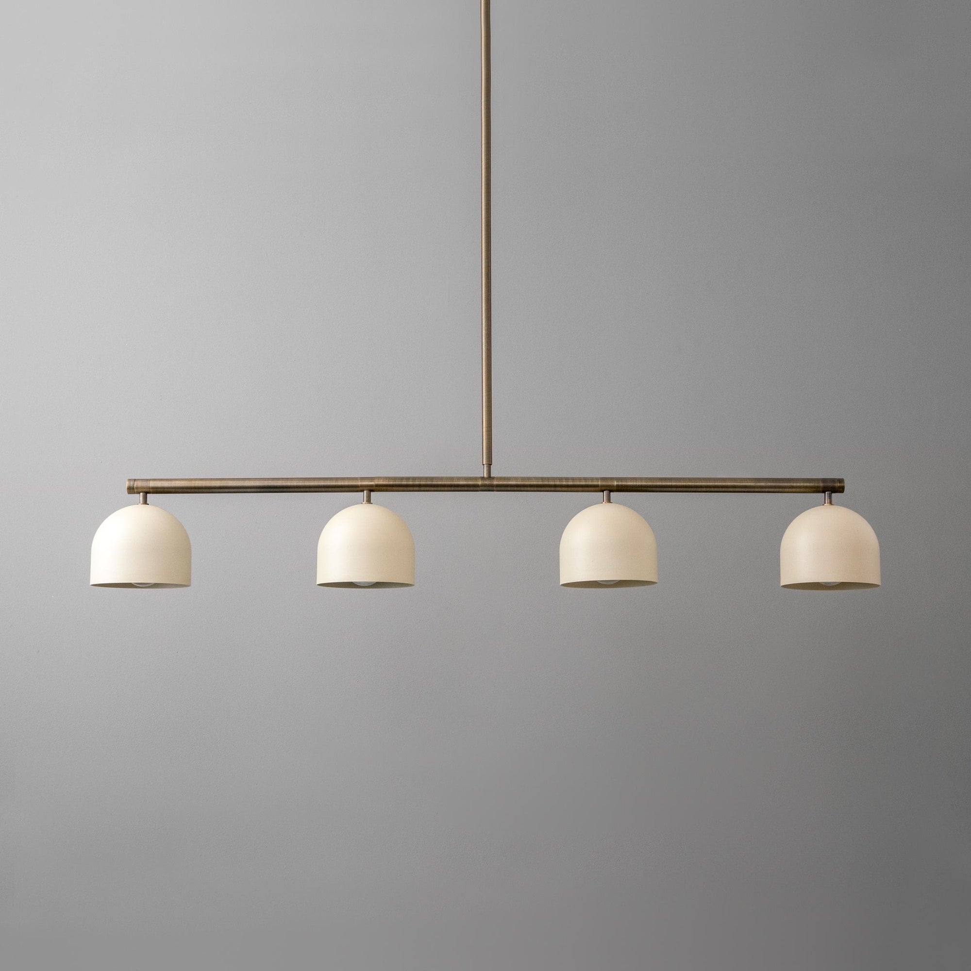 Linear chandelier with four matte white globe shades and antique brass finish rod. - CHANDELIER MODEL NO. 7998