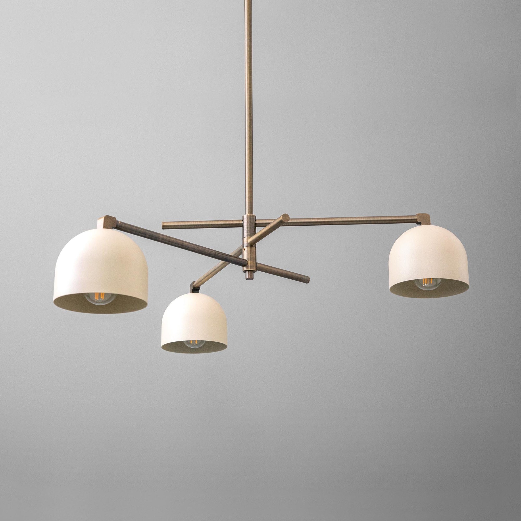 Industrial three-arm chandelier with antique brass finish and cream swivel shades. - CHANDELIER MODEL NO. 9965