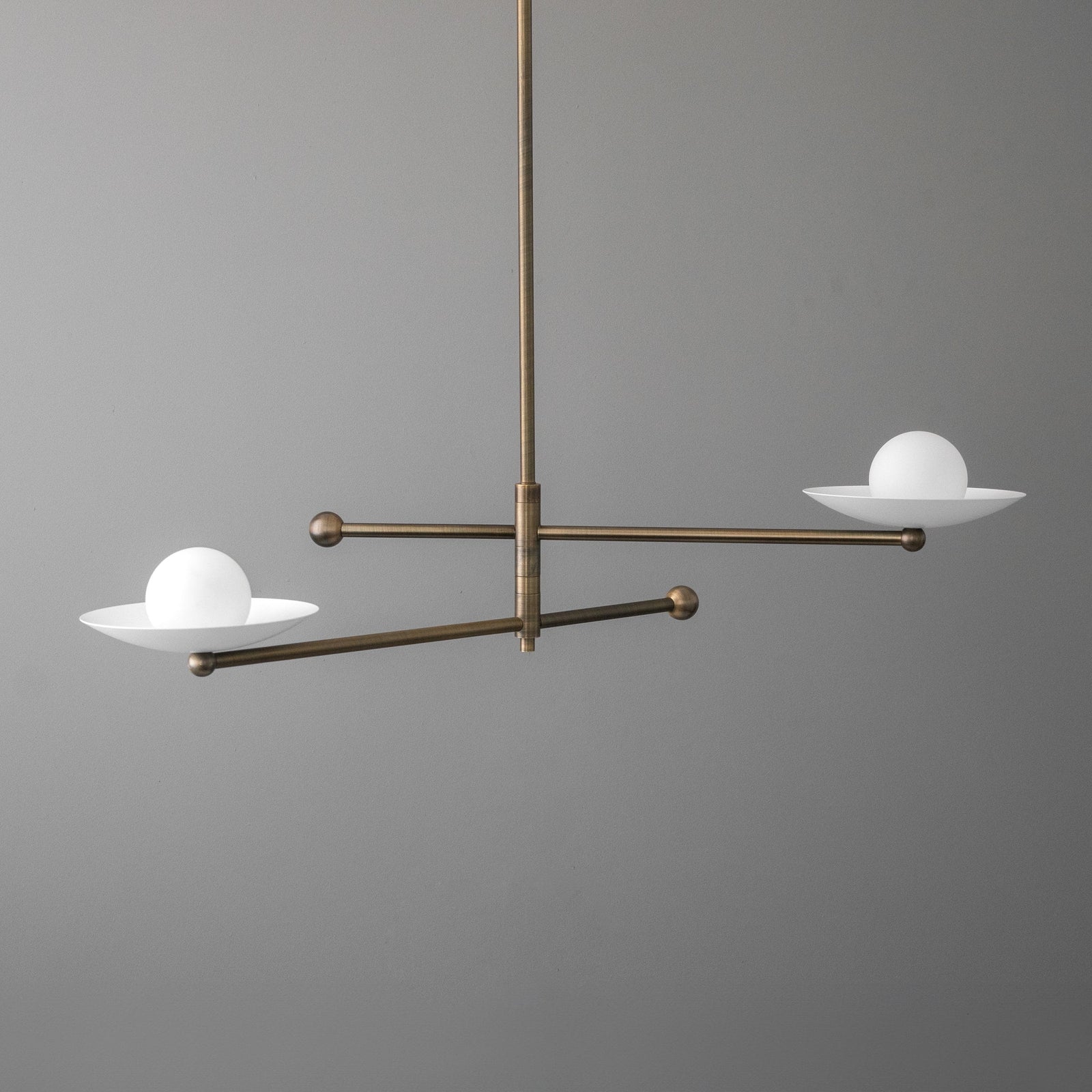 Mid-century modern chandelier with antique brass finish and two white globe lights on horizontal arms. - CHANDELIER MODEL NO. 2933