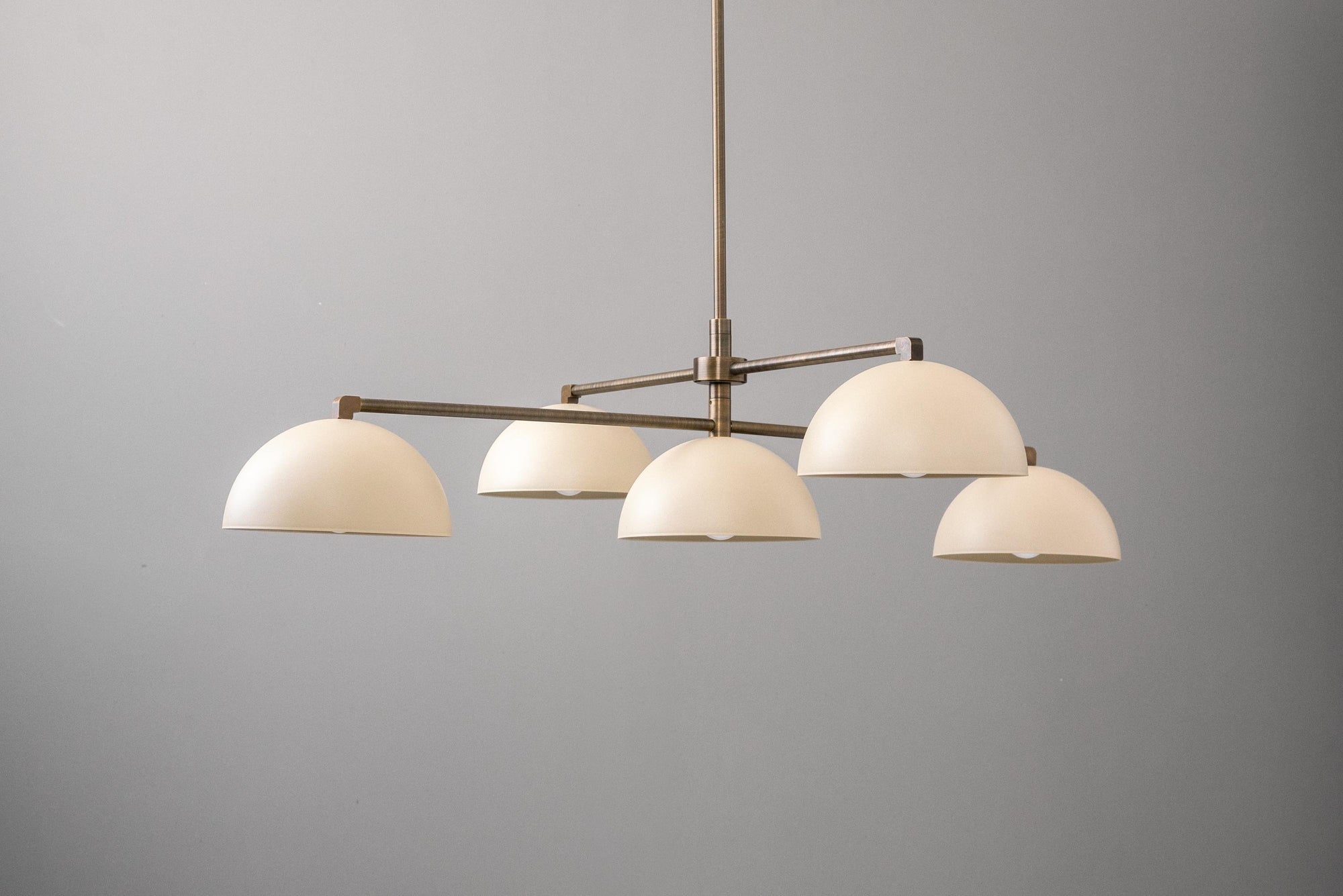 Mid-century modern chandelier with five dome-shaped white shades and antique brass finish. - CHANDELIER MODEL NO. 7041