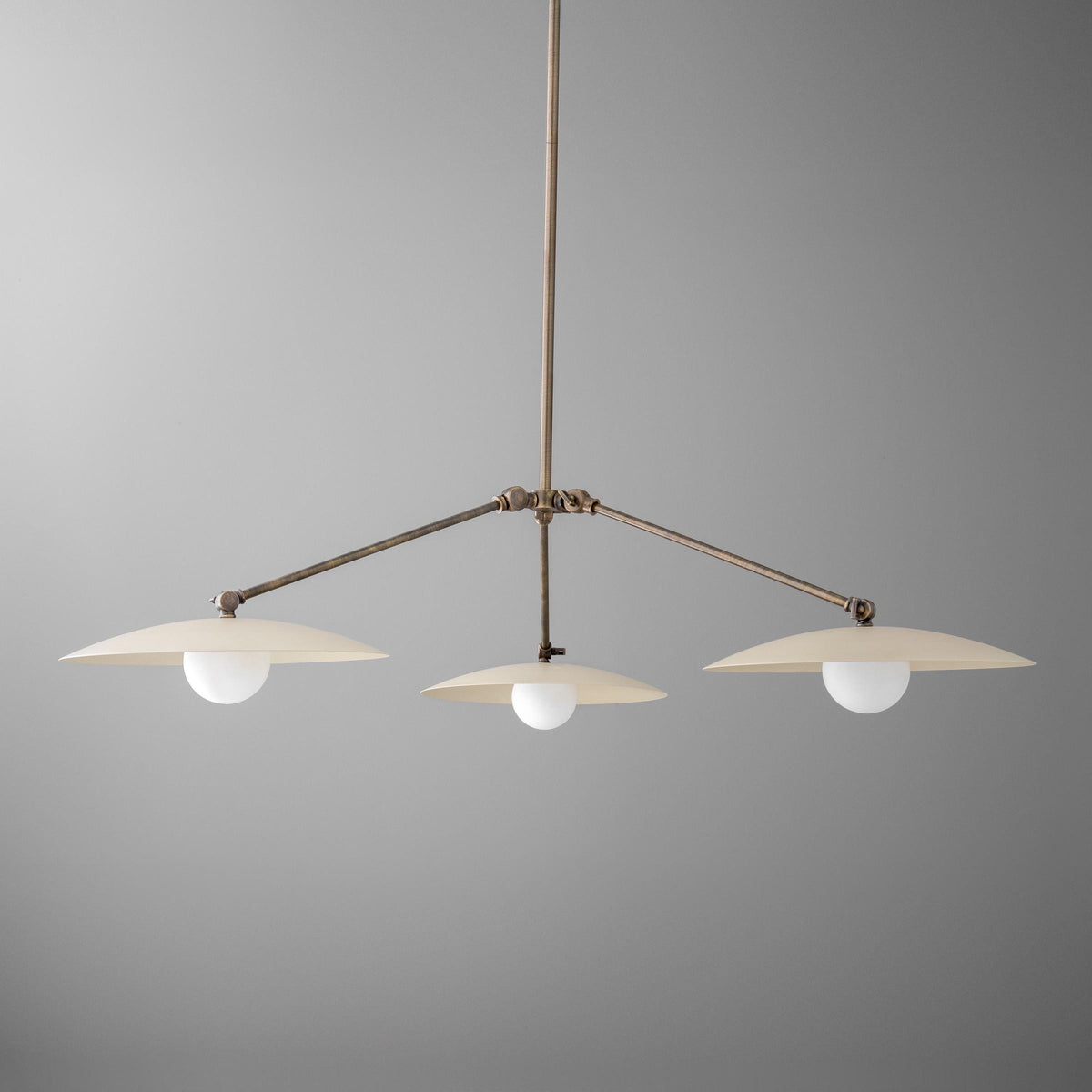 Antique brass chandelier with three flat disc shades and round white bulbs suspended on a rod. - CHANDELIER  MODEL NO. 7014