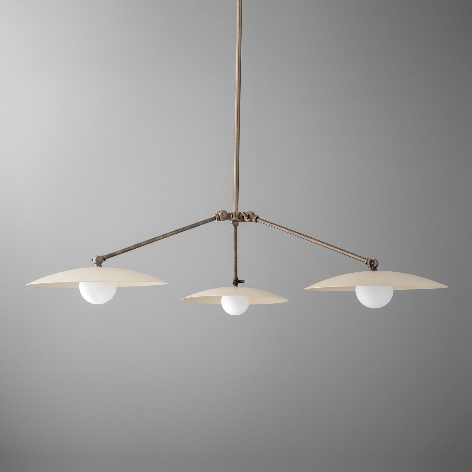 Antique brass chandelier with three flat disc shades and round white bulbs suspended on a rod. - CHANDELIER  MODEL NO. 7014