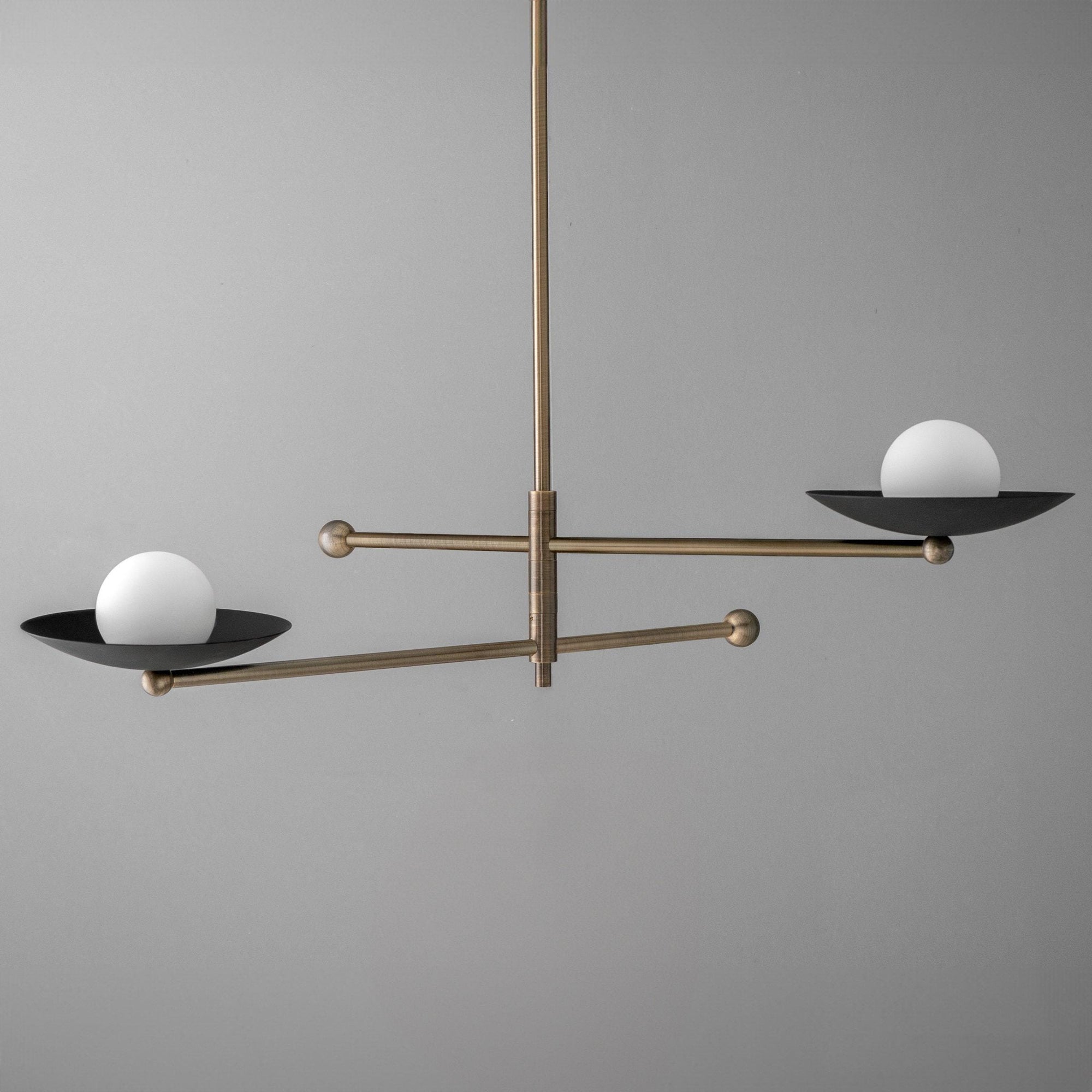 Mid-century modern chandelier with antique brass arms and two white globe lights on black circular bases. - CHANDELIER MODEL NO. 2933