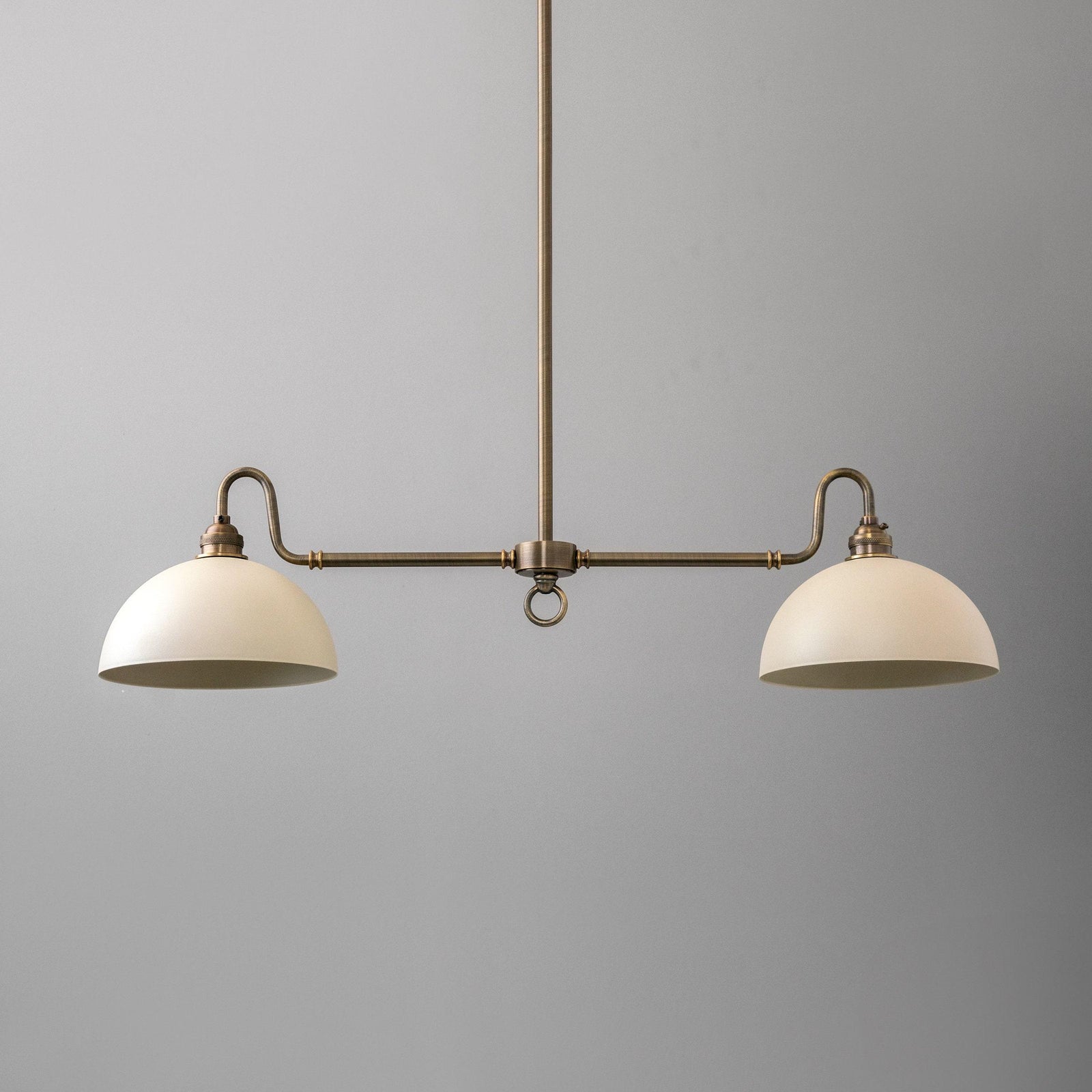 Antique brass farmhouse chandelier with two white dome-shaped shades and linear design. - CHANDELIER MODEL NO. 8764