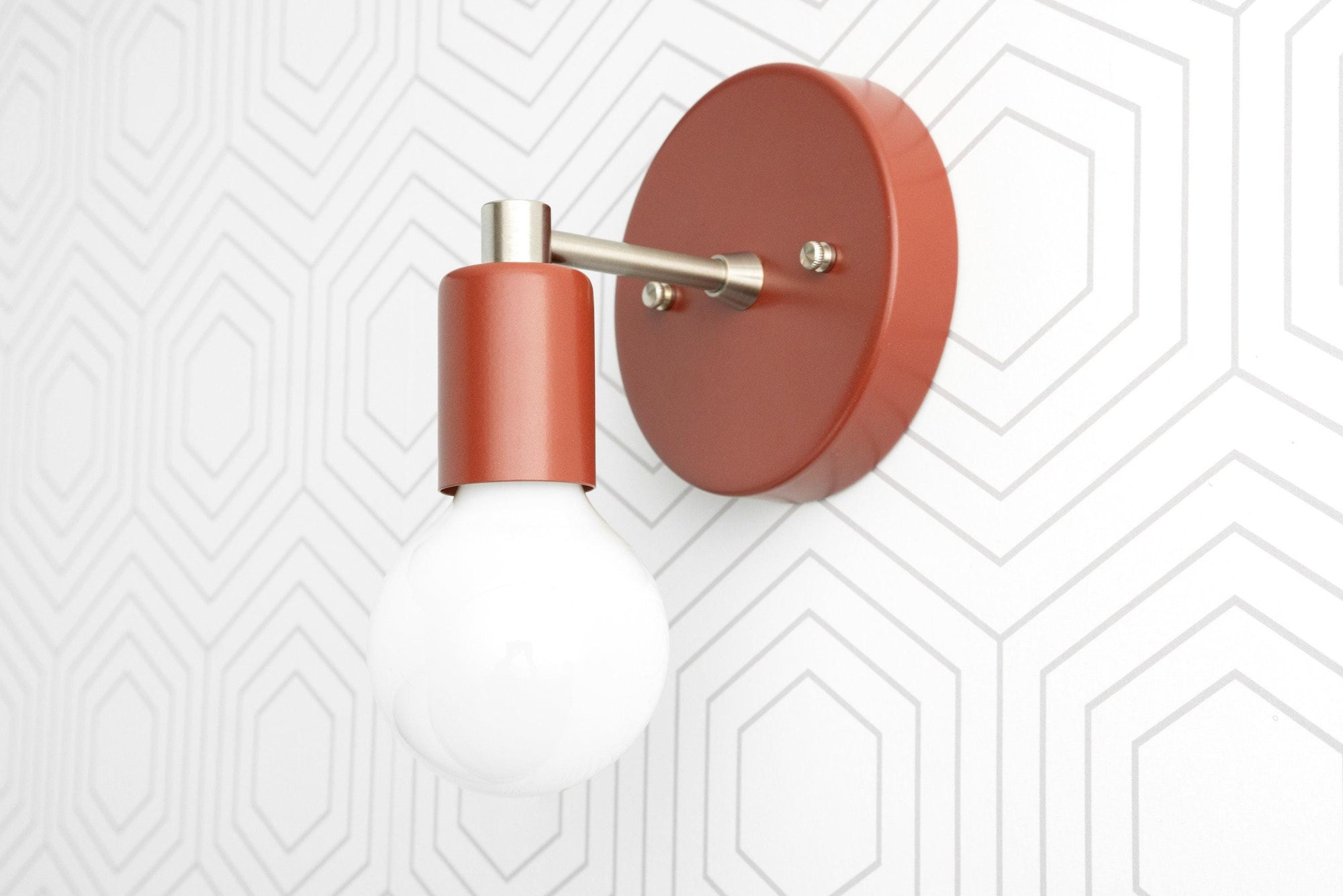 Wall-mounted sconce in matte terracotta with brass accents and exposed round bulb. - SCONCE MODEL NO. 9036