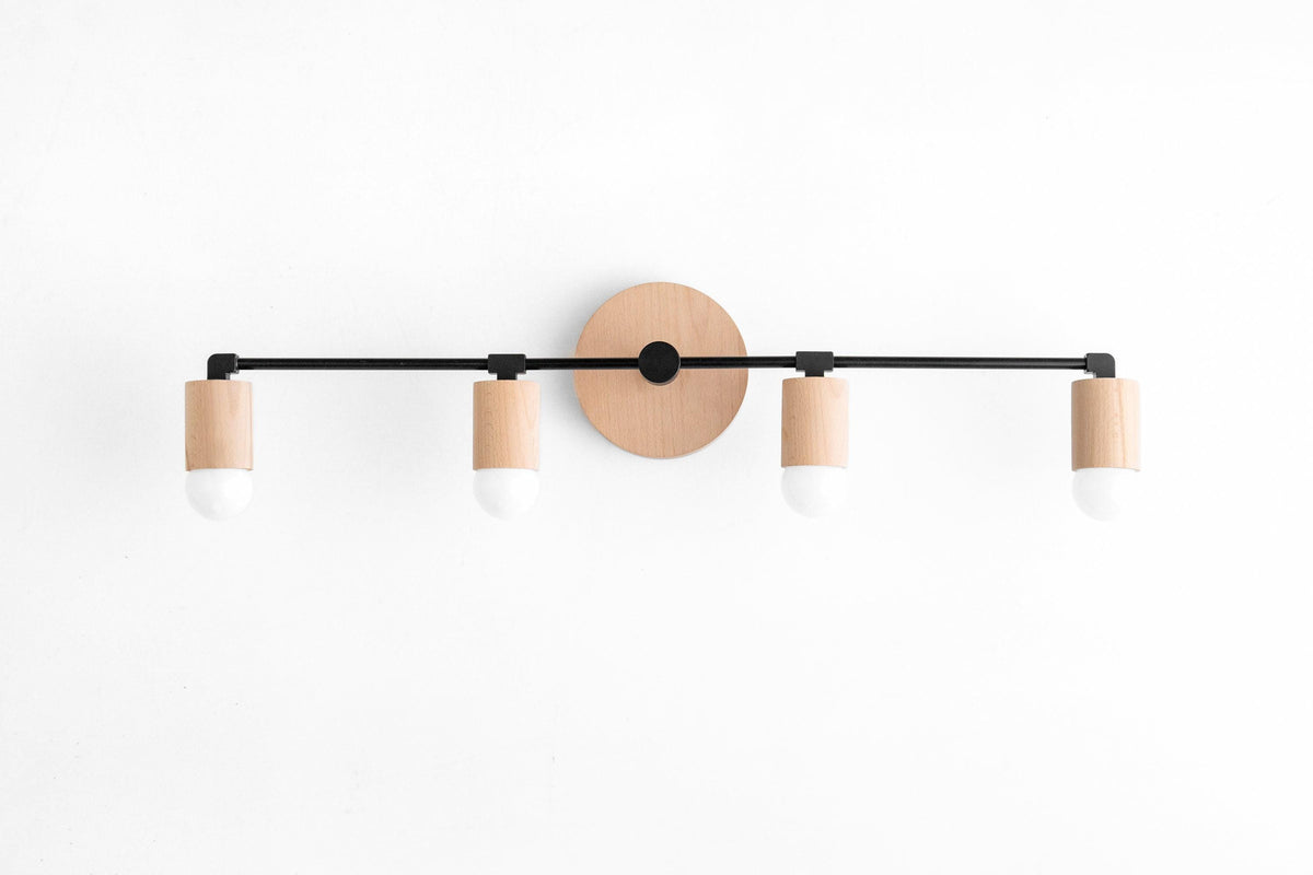 Four-bulb vanity light with black metal rod and natural wood accents on white wall. - VANITY LIGHT MODEL NO. 2017