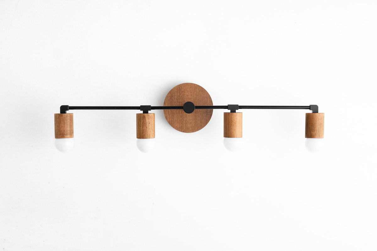 Four-bulb vanity light with black metal frame and natural oak wood accents on wall mount. - VANITY LIGHT MODEL NO. 2017
