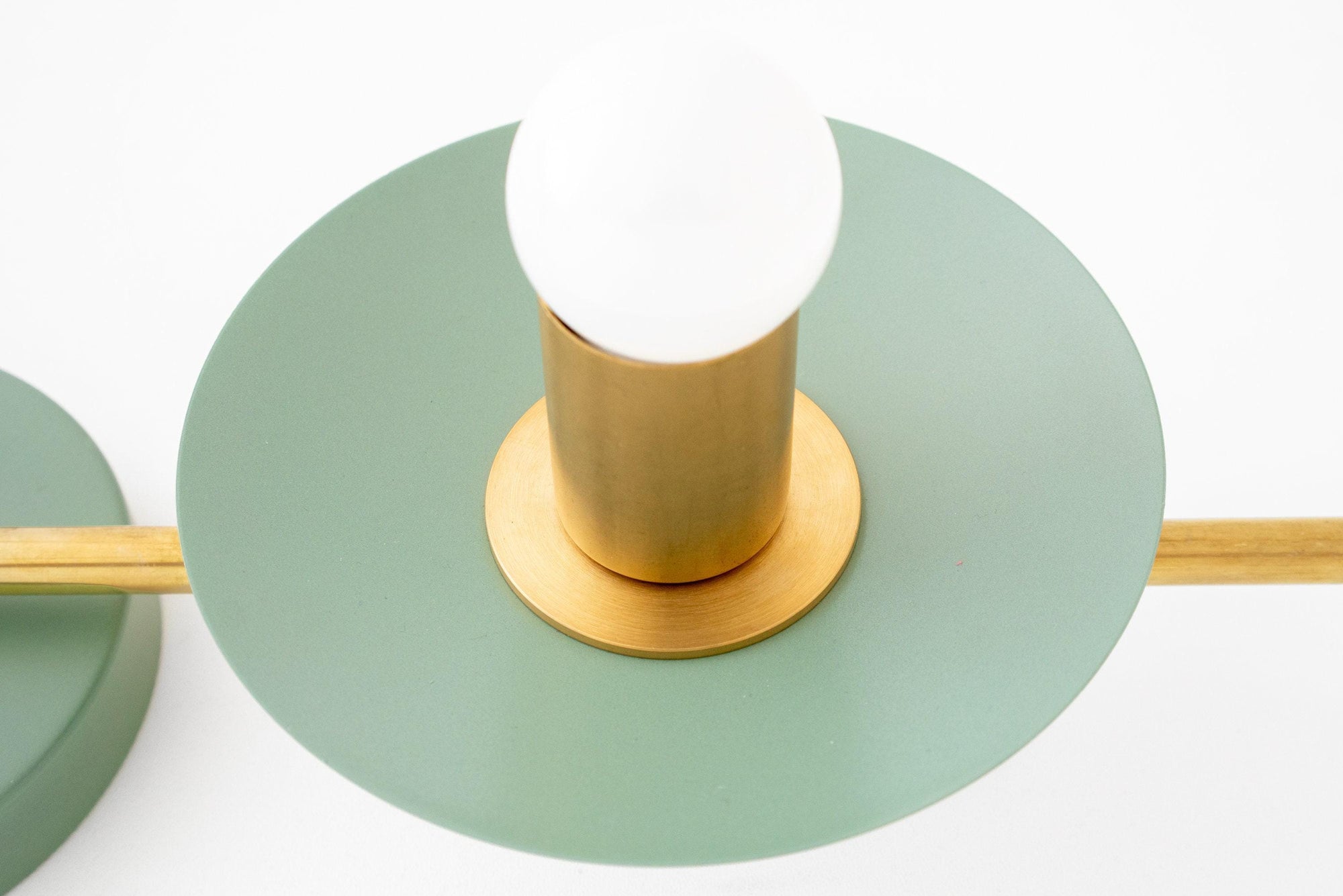 Raw brass vanity light with green circular metal shade and exposed bulb. - VANITY LIGHT MODEL NO. 8151