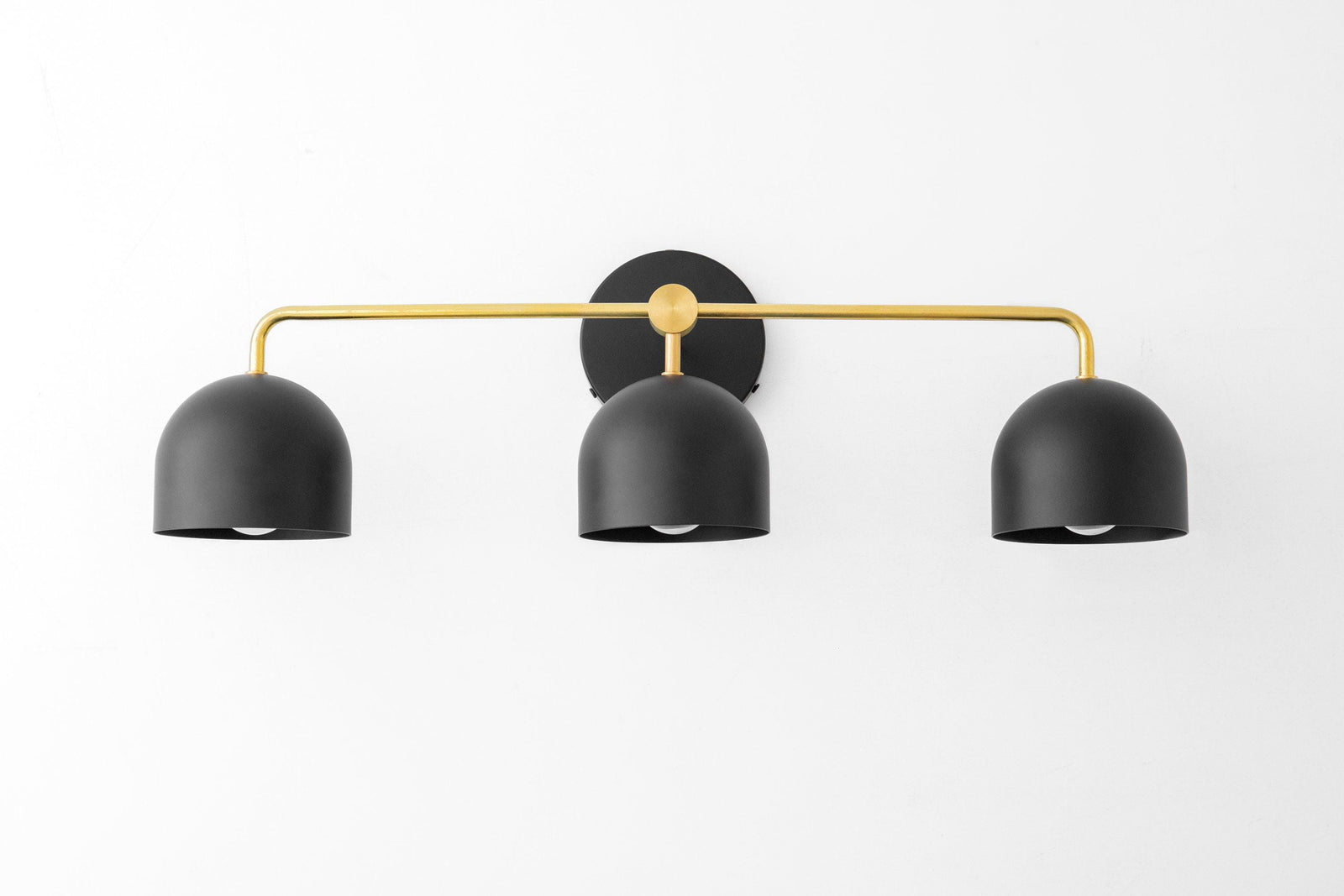 Mid-century modern vanity light with three black dome shades and a brass horizontal bar mount. - VANITY LIGHT MODEL NO. 7456