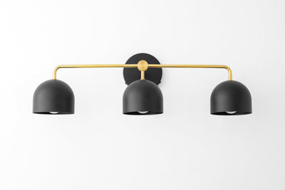 Mid-century modern black three-bulb vanity light with curved brass arm and round wall mount. - VANITY LIGHT MODEL NO. 7456