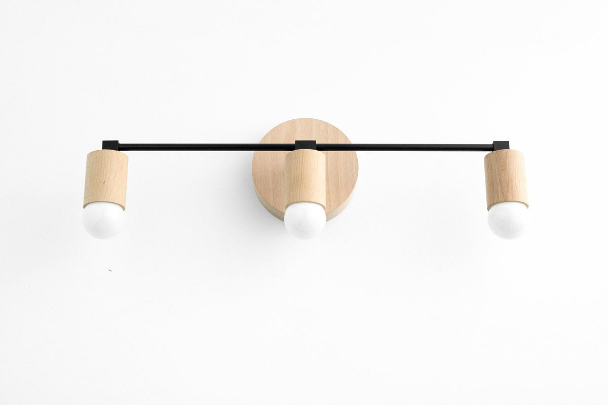 Three-bulb vanity light with black metal bar and natural beech wood accents. - VANITY LIGHT MODEL NO. 4446