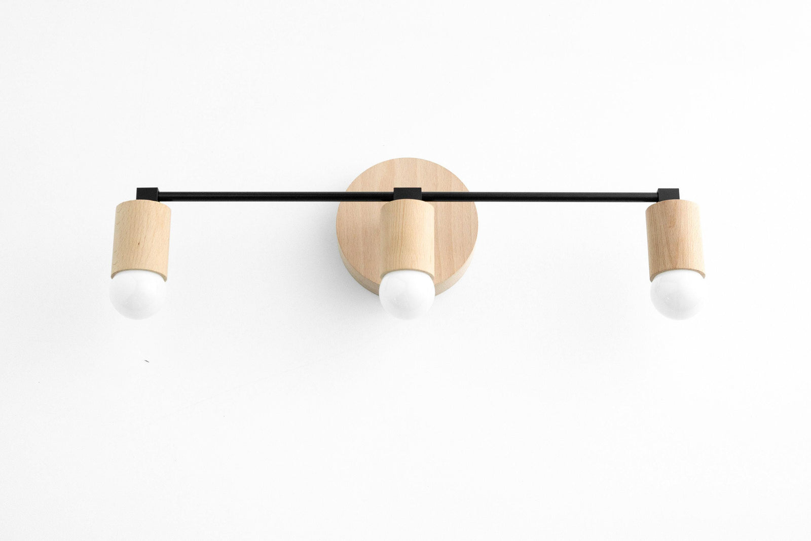 Three-bulb vanity light with black metal bar and natural beech wood accents. - VANITY LIGHT MODEL NO. 4446