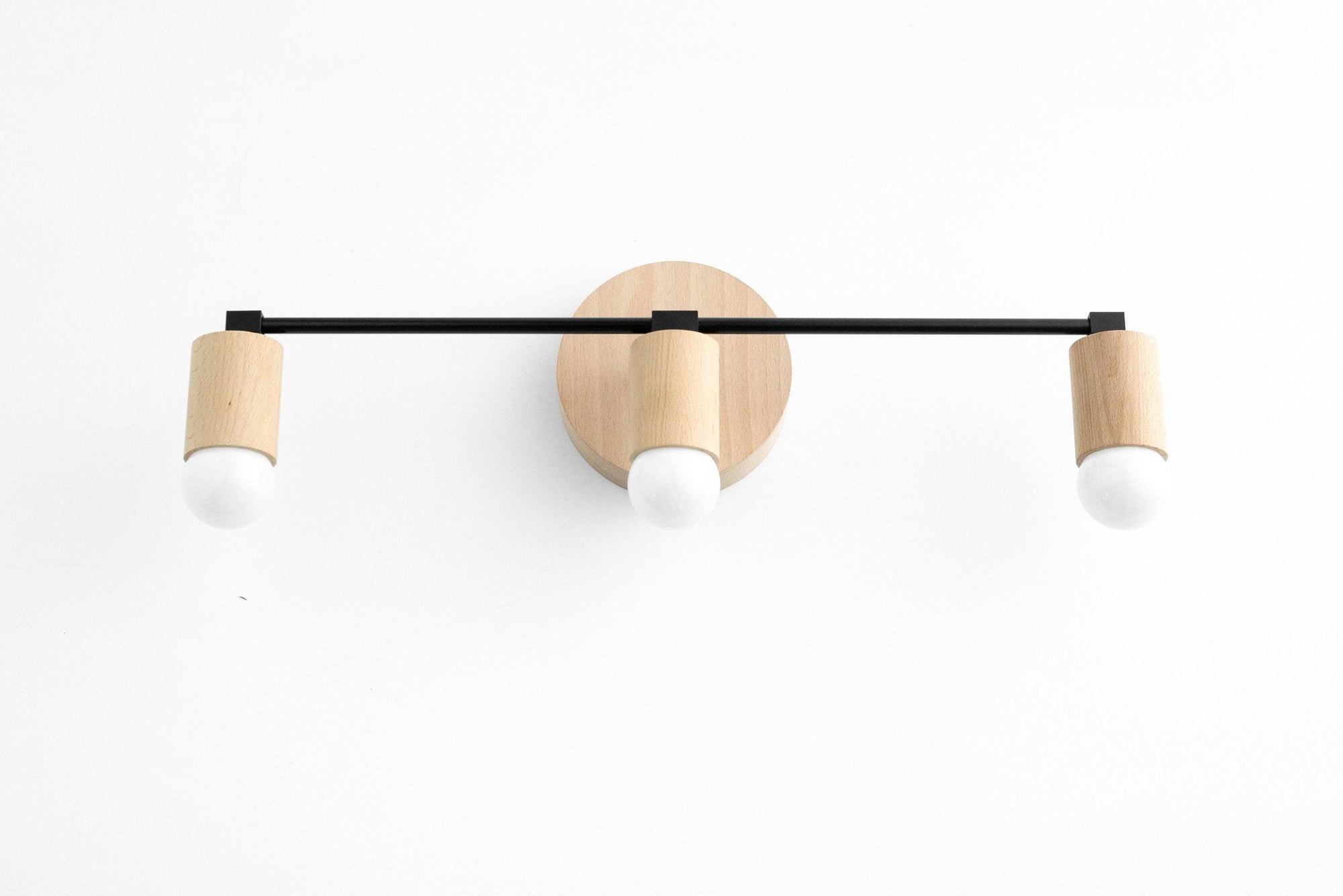 Three-bulb vanity light with black metal bar and natural beech wood accents. - VANITY LIGHT MODEL NO. 4446