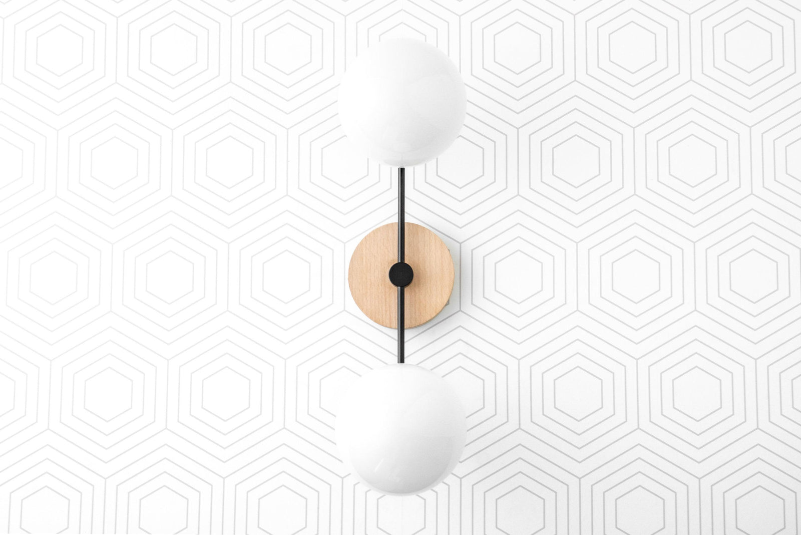 Two-bulb vanity light with matte black metal frame, natural wood wall mount, and frosted globe bulbs. - VANITY LIGHT MODEL NO. 9474