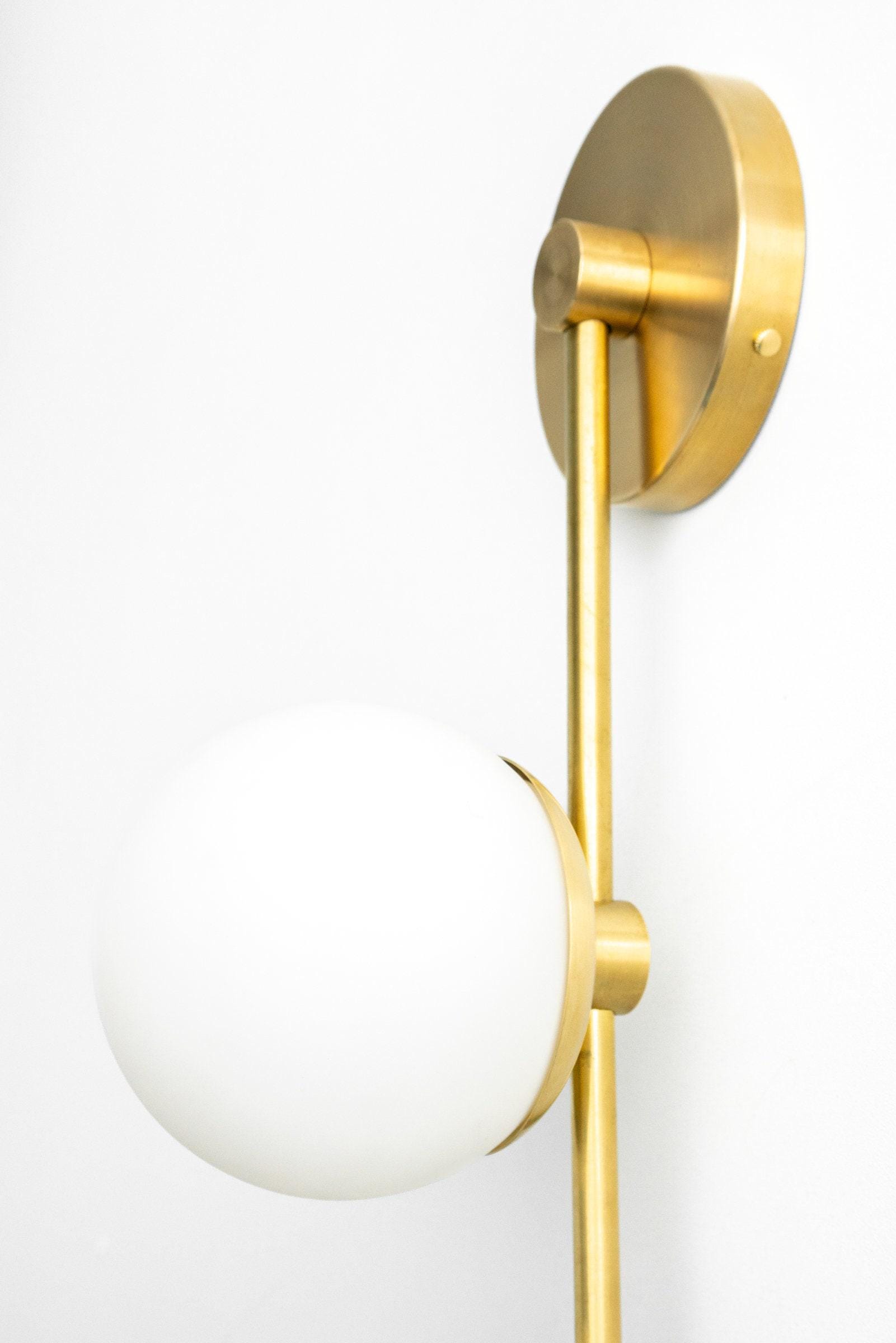Mid-century modern wall sconce with sealed brass finish and frosted white globe shade. - SCONCE MODEL NO. 0344