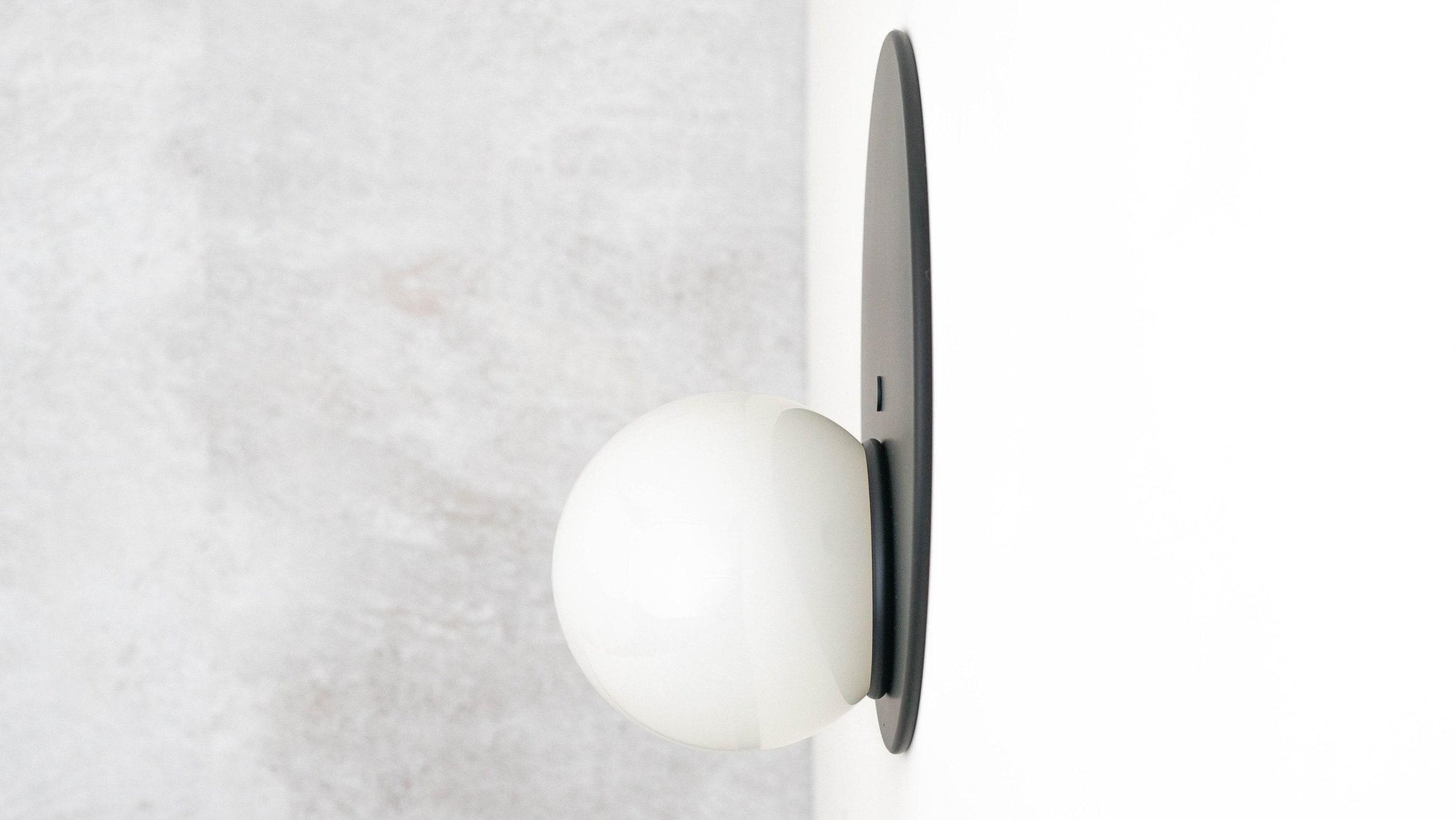 Mid-century modern black wall sconce with white globe shade and slim backplate. - SCONCE MODEL NO. 6703