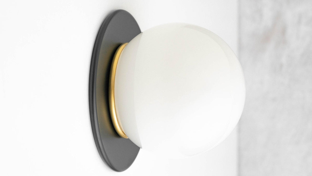 Mid-century modern wall sconce with matte black round backplate and frosted white globe light. - SCONCE MODEL NO. 9364