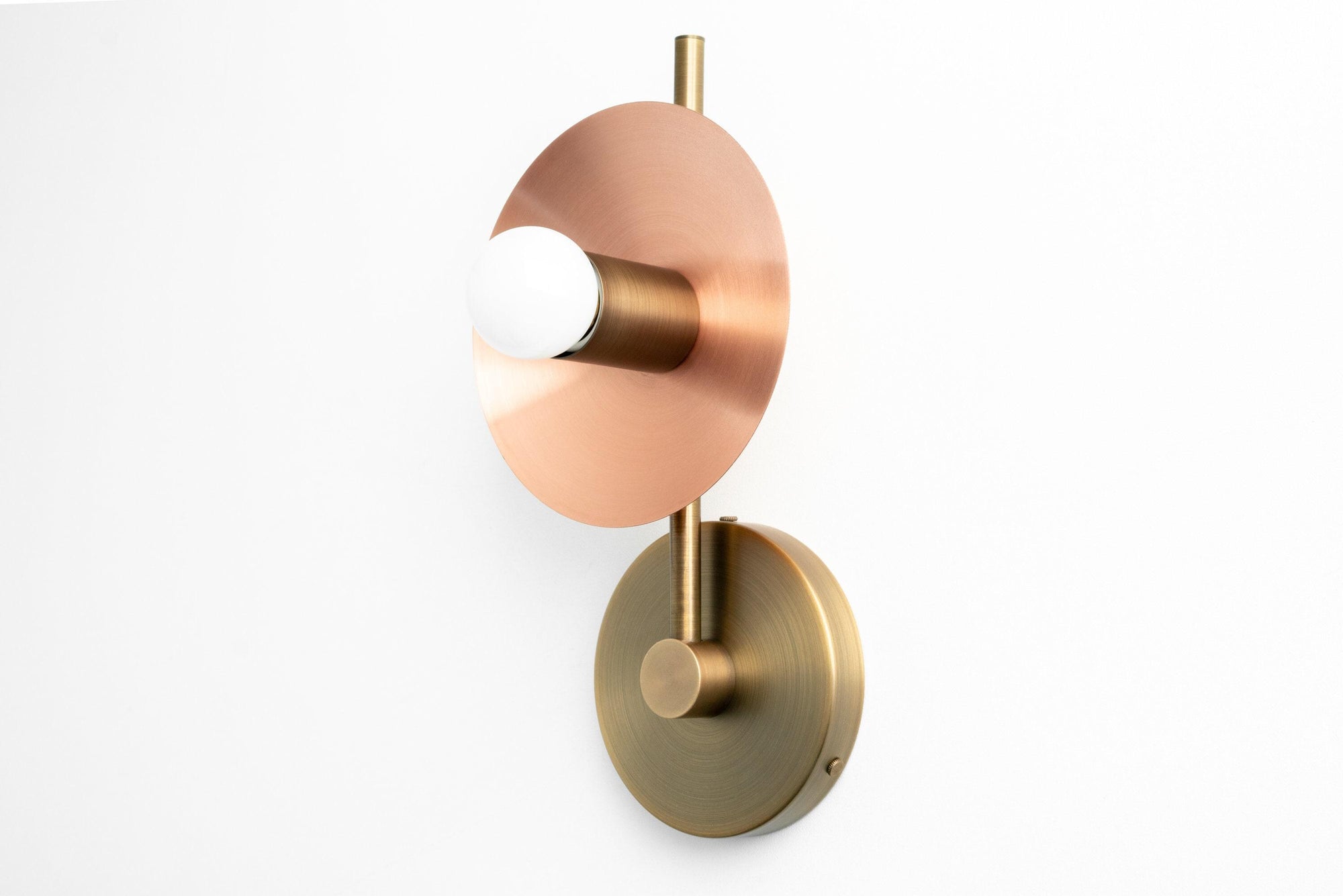 Art Deco wall sconce with raw brass base, copper disk, and exposed bulb design. - SCONCE MODEL NO. 2693