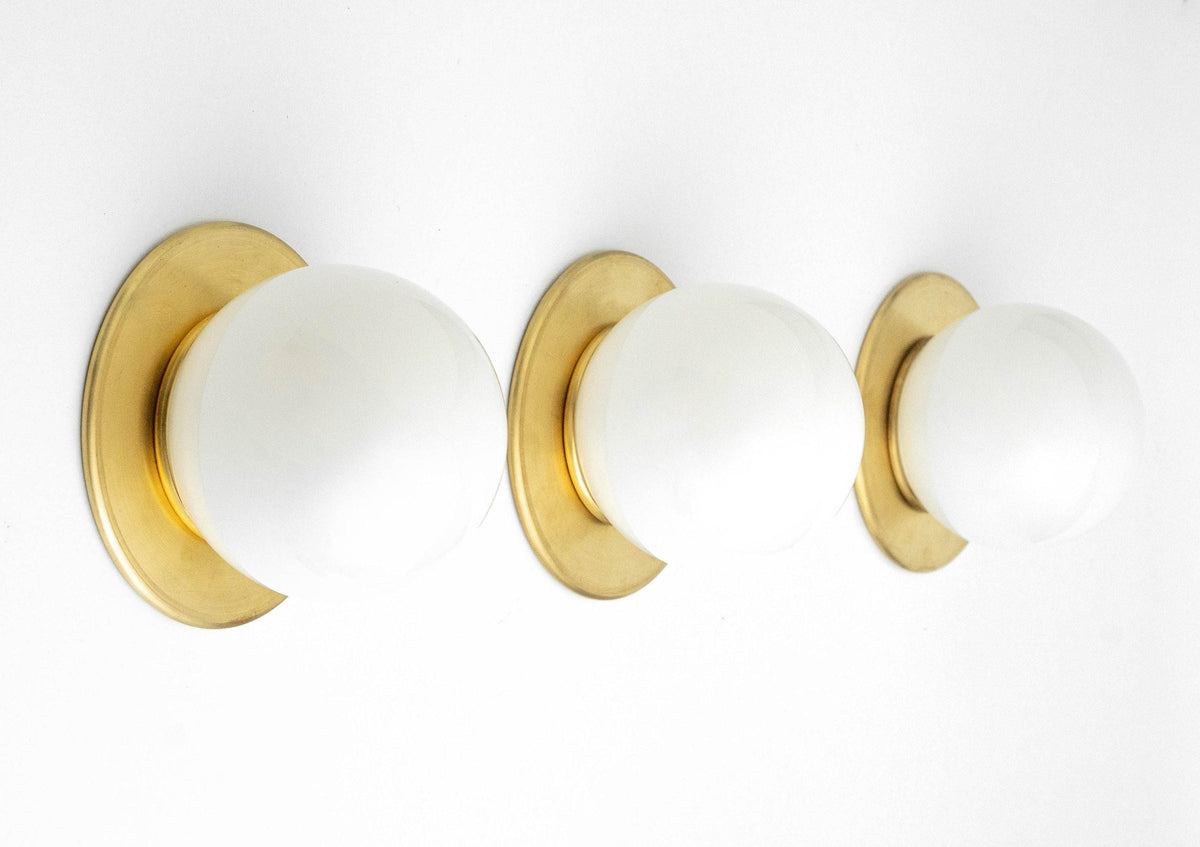 Triple mid-century modern flush mount sconce with round white glass globes and raw brass bases. - SCONCE MODEL NO. 9364