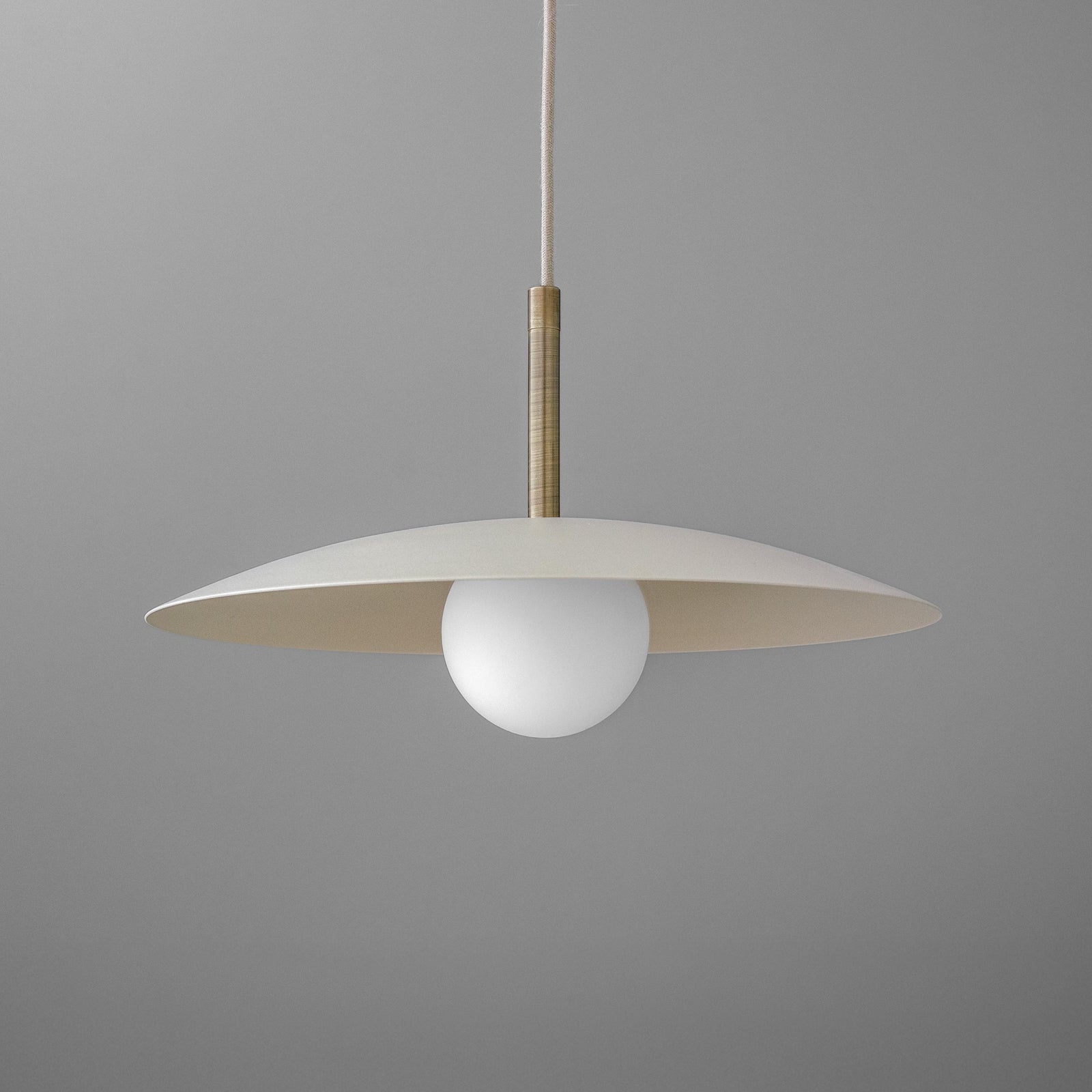 Minimal pendant light with wide beige metal disc shade and white globe bulb suspended by a slim rod. - PENDANT MODEL NO. 5693