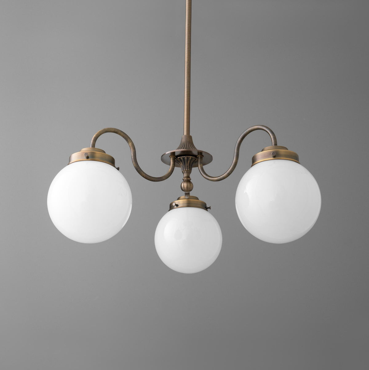 Three-light chandelier in antique brass finish with white glass globe shades and curved arms. - CHANDELIER MODEL NO. 5877