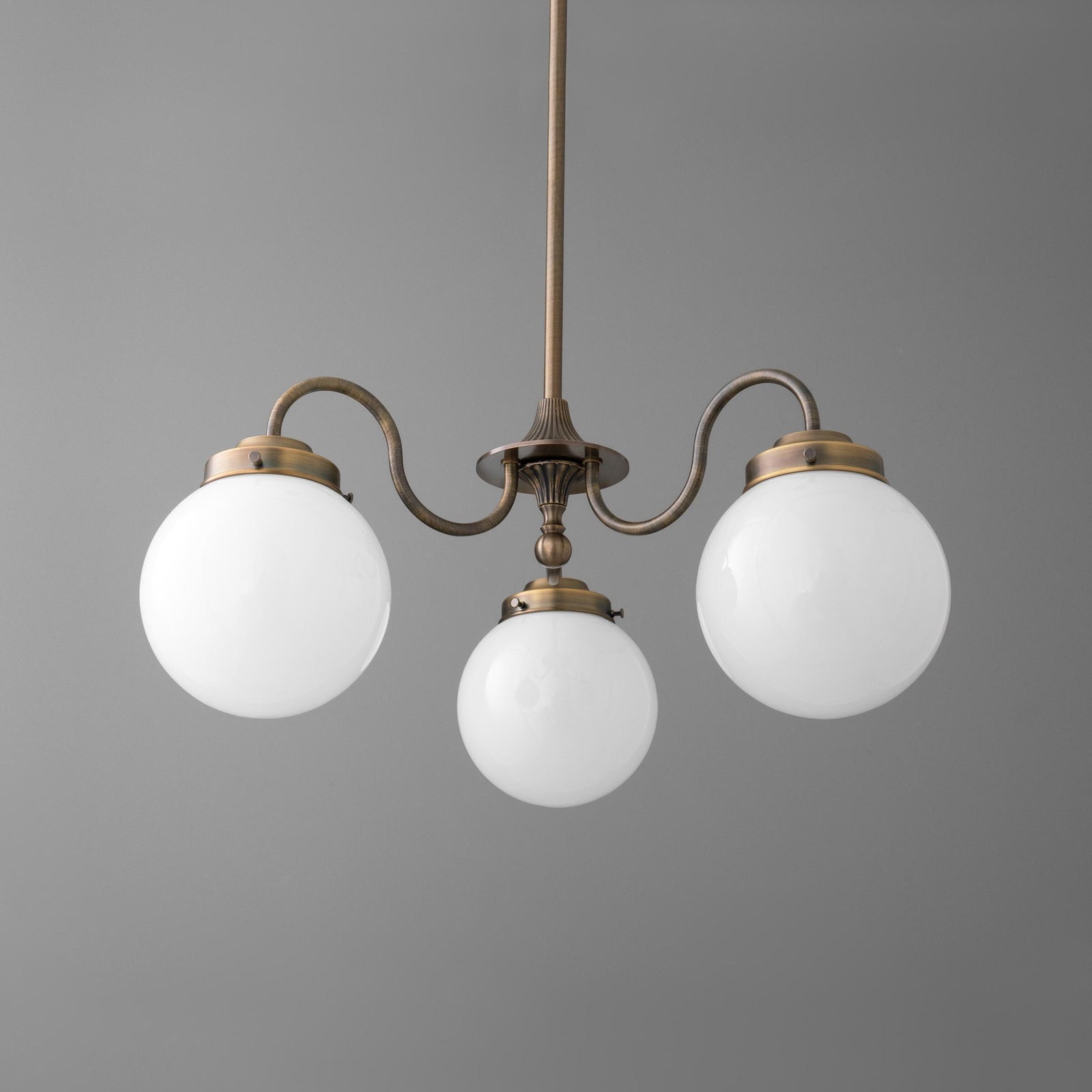 Three-light chandelier in antique brass finish with white glass globe shades and curved arms. - CHANDELIER MODEL NO. 5877