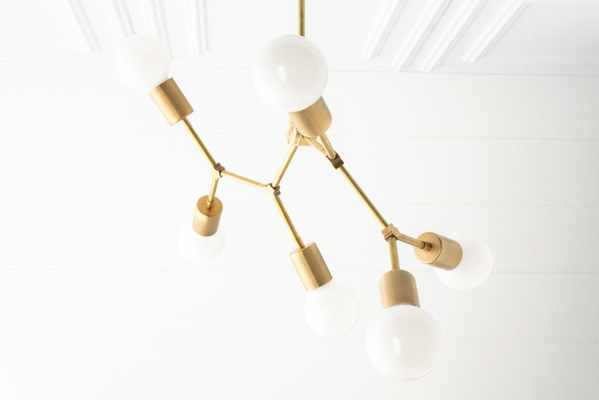 Raw brass Art Deco chandelier with six bare bulb sockets and white globe bulbs. - CHANDELIER MODEL NO. 2523