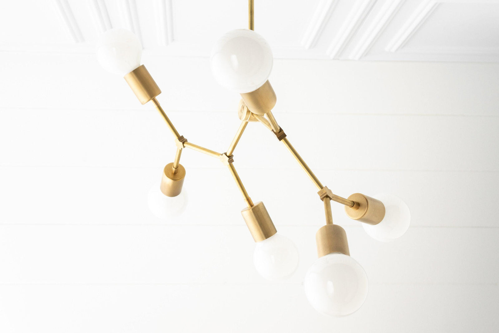 Raw brass Art Deco chandelier with six bare bulb sockets and white globe bulbs. - CHANDELIER MODEL NO. 2523