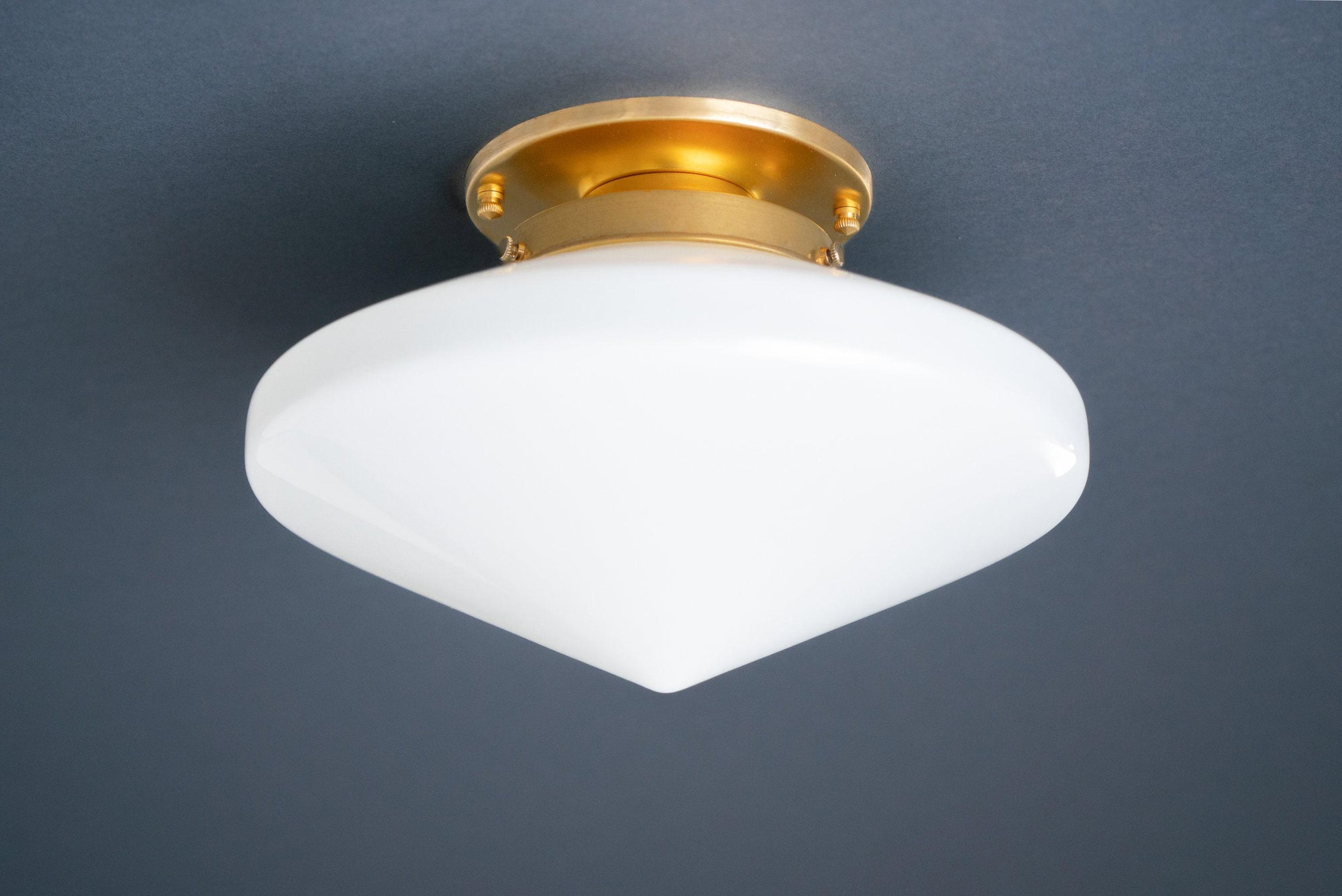 Flush mount ceiling light with white glass globe and raw brass fixture base. - CEILING LIGHT MODEL NO. 5862