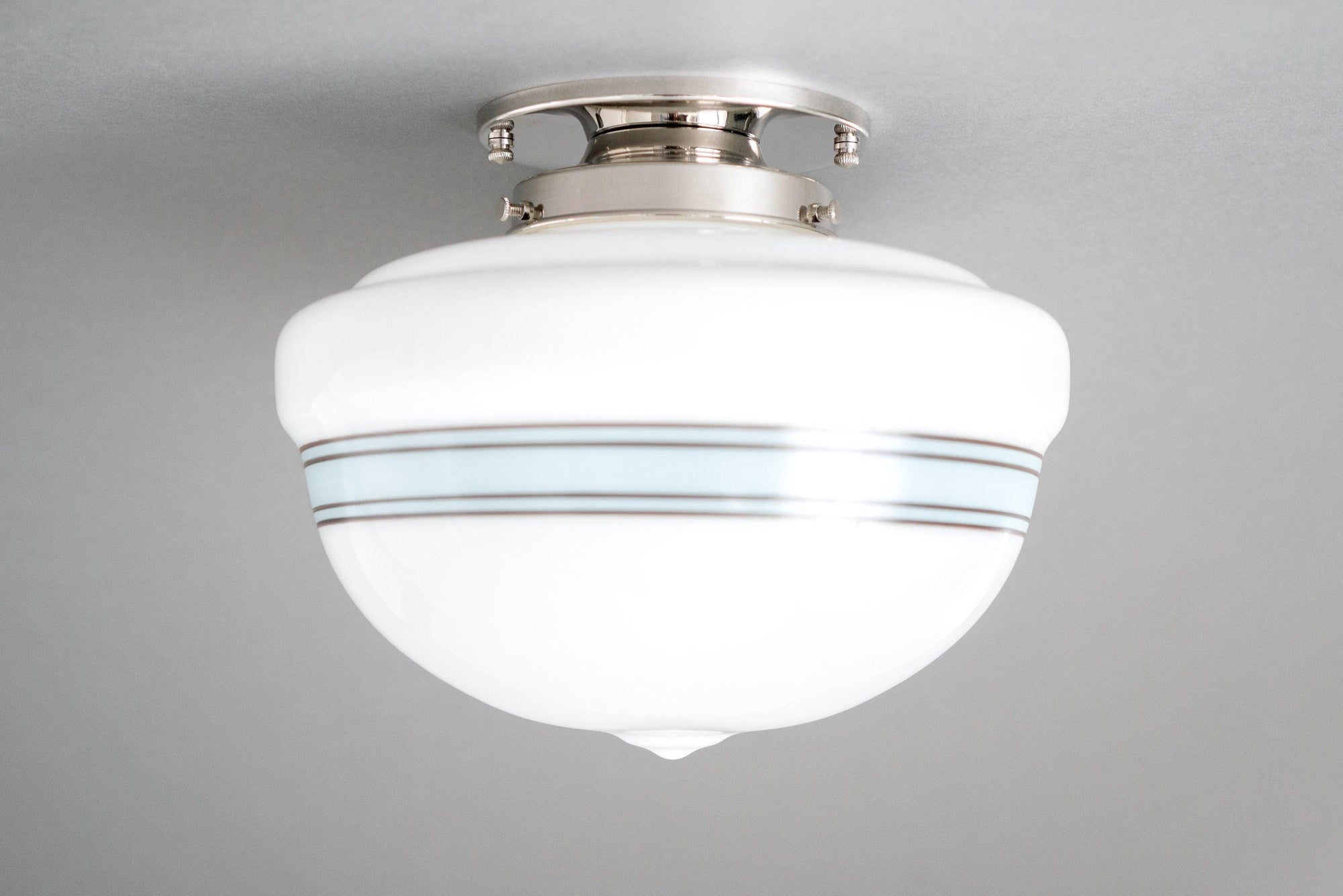 Art Deco flush mount ceiling light with polished nickel finish and white glass globe with blue stripes. - CEILING LIGHT MODEL NO. 9927