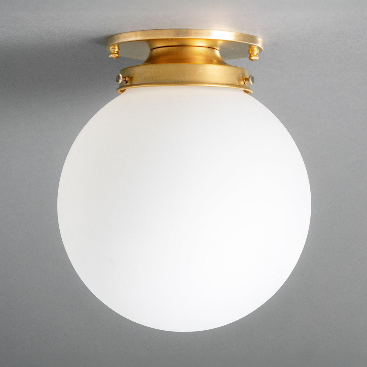 Flush mount ceiling light with a brass canopy and fitter holding a round opal glass globe. - CEILING LIGHT MODEL NO. 1163