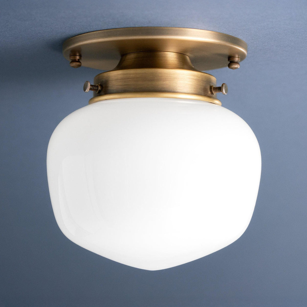Flush mount ceiling light in Antique Brass with a round canopy and an opal glass acorn shade. - CEILING LIGHT MODEL NO. 2019