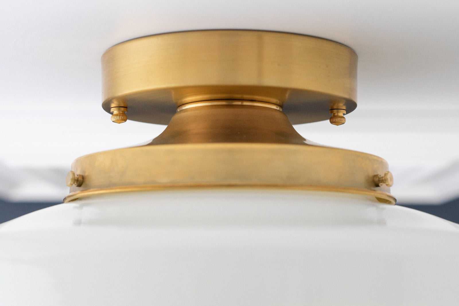 Flush mount ceiling light with raw brass fixture and smooth white globe shade. - CEILING LIGHT MODEL NO. 7458