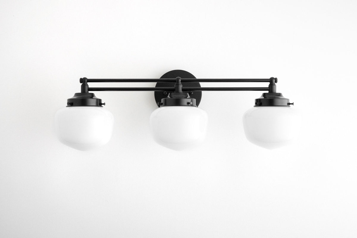 Three-globe black Art Deco vanity light fixture with round wall mount and opaque white glass shades. - VANITY LIGHT MODEL NO. 4352