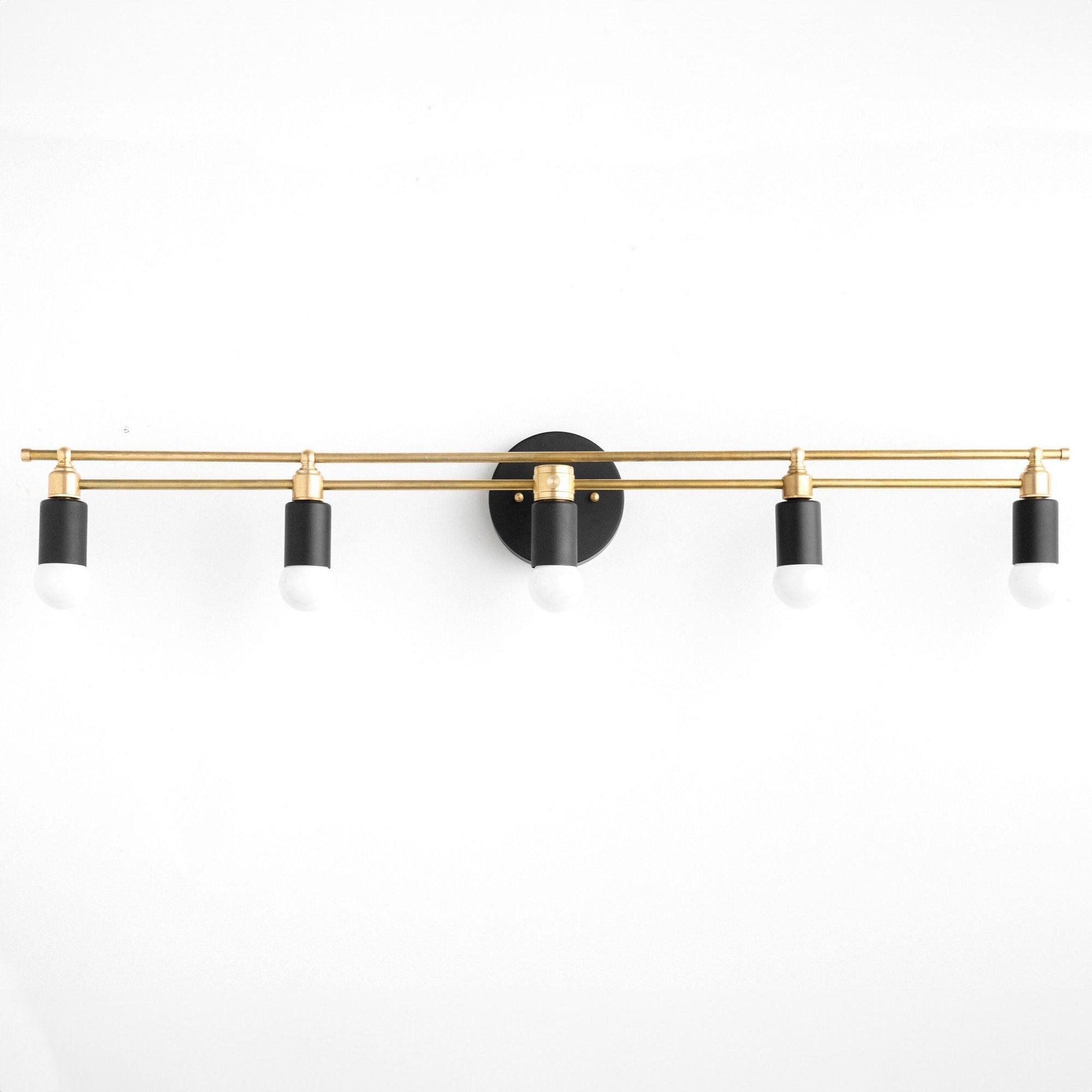 Art Deco style vanity light with five black and brass bare bulb sockets on a horizontal brass bar. - VANITY LIGHT MODEL NO. 3933