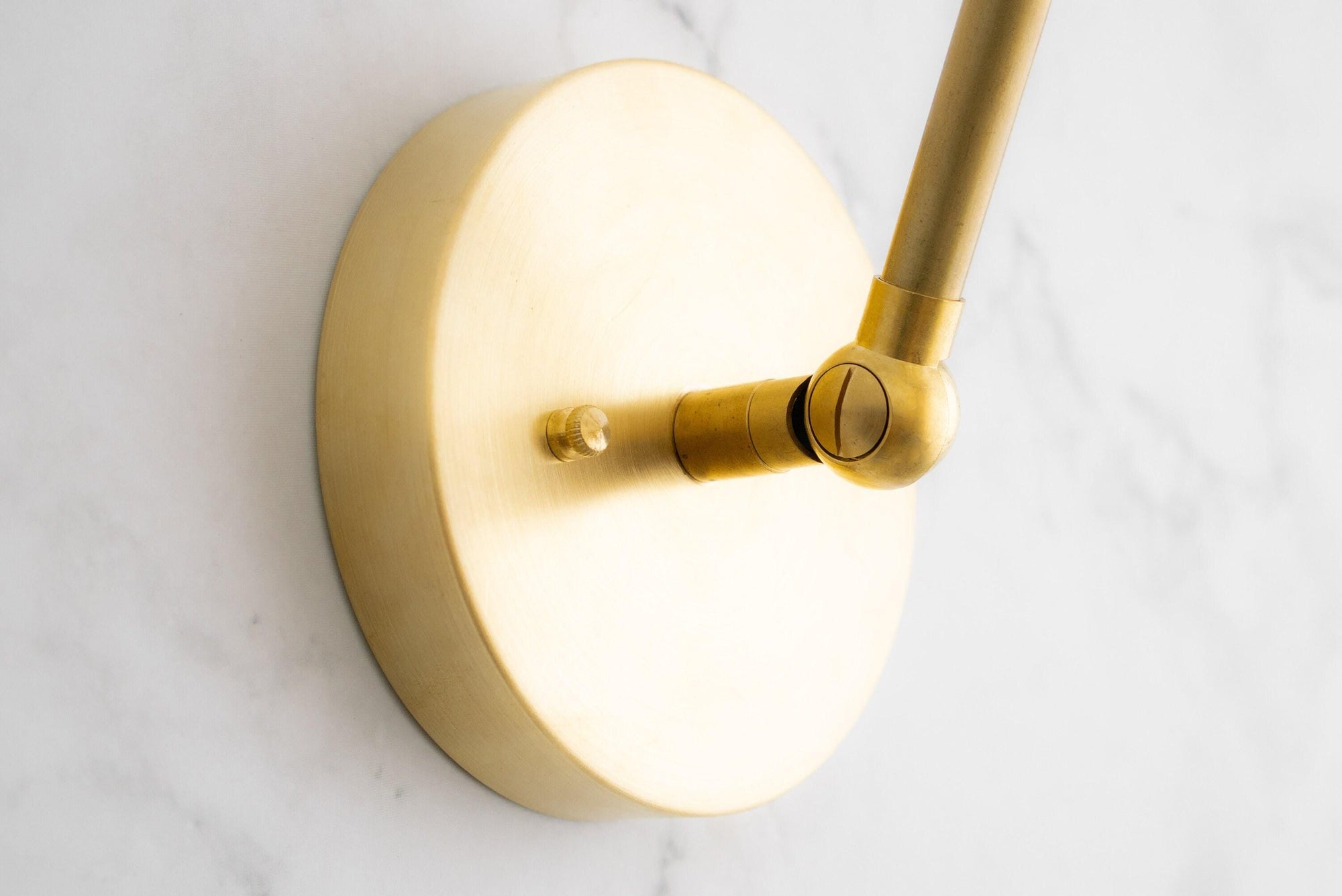 Raw brass adjustable wall sconce base with smooth round backplate and swivel joint. - SCONCE MODEL NO. 0107