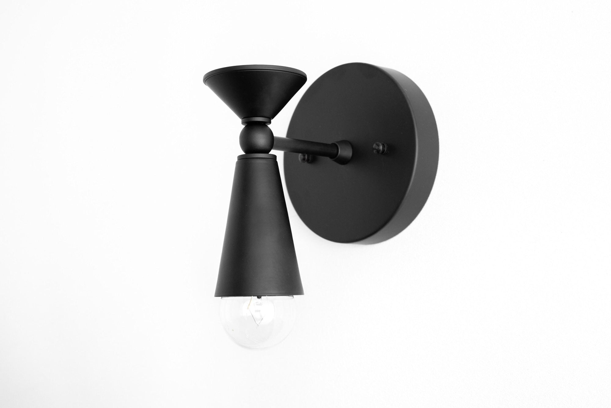 Black metal Art Deco wall sconce with exposed bulb and conical shade. - SCONCE MODEL NO. 8393