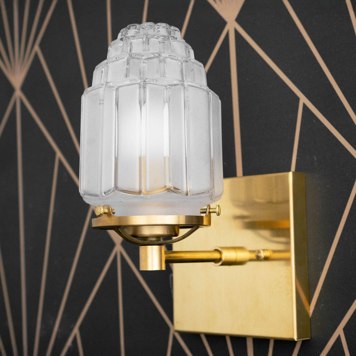 Sconce in Raw or Sealed Brass with a square backplate and a tiered ribbed shade. - SCONCE MODEL NO. 5513