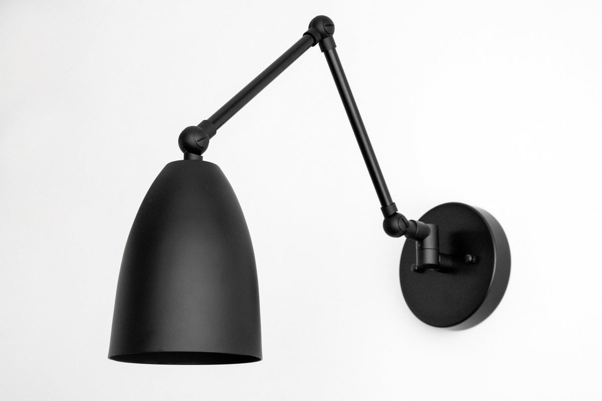 Matte black adjustable wall sconce with bell-shaped shade and round mounting plate. - SCONCE MODEL NO. 0107