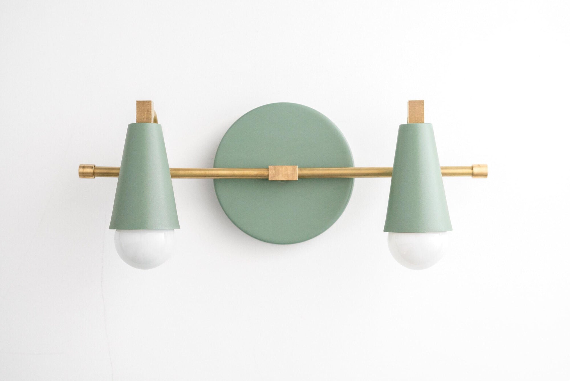 Two-bulb vanity light with matte green cone shades and raw brass horizontal bar on round green base. - VANITY LIGHT MODEL NO. 1229