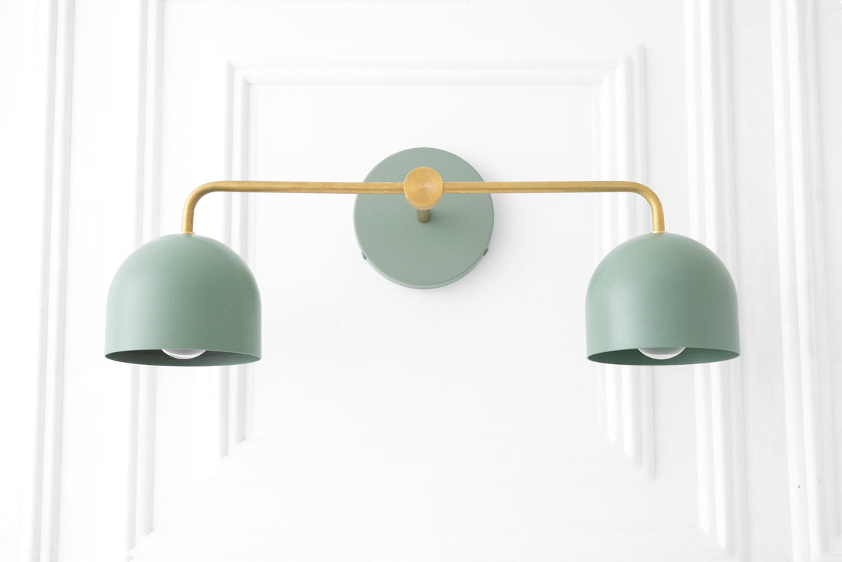 Art Deco style vanity light with two matte green metal shades and raw brass horizontal bar mounting. - VANITY LIGHT MODEL NO. 2082