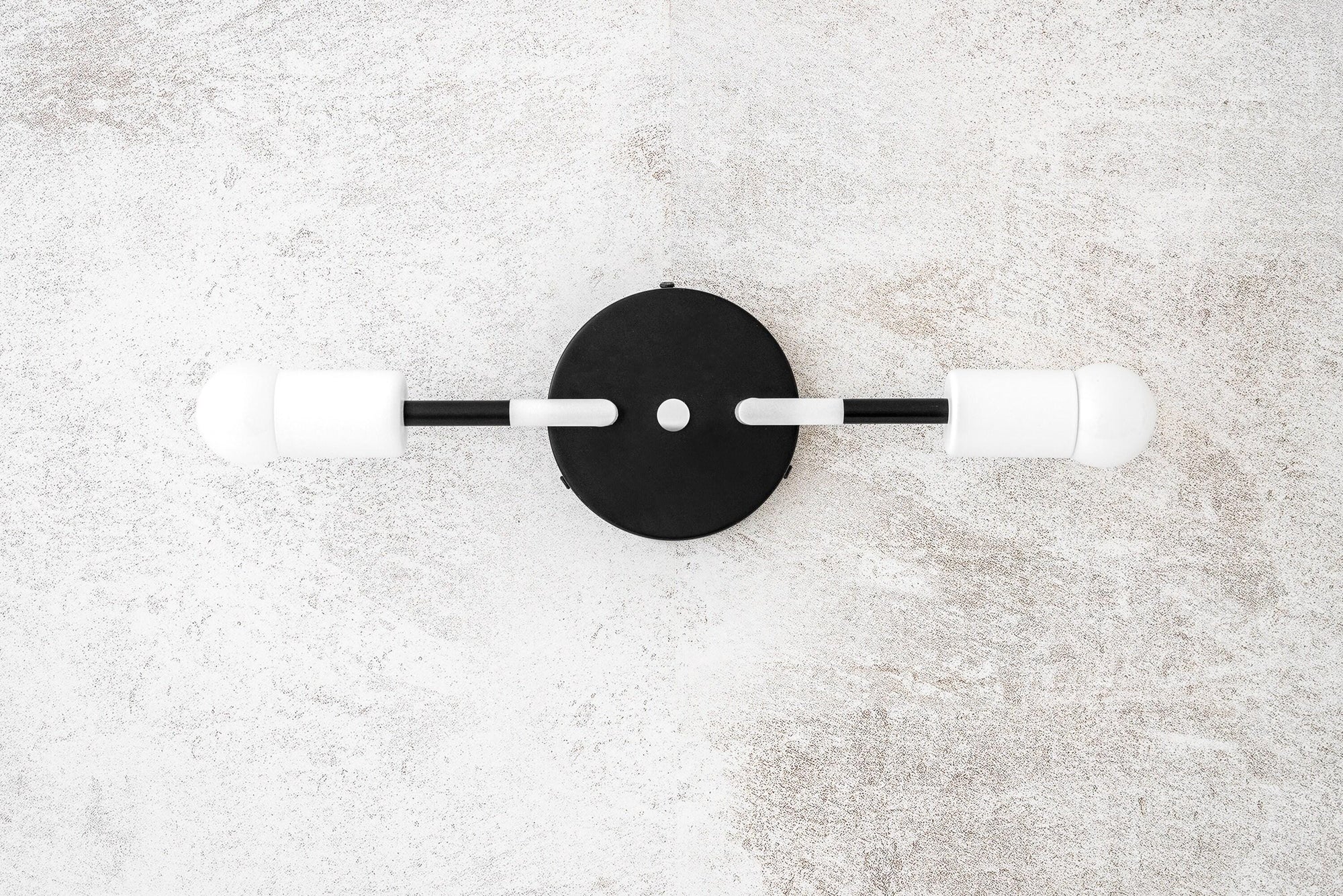 Minimalist black metal vanity light with two exposed white bulbs and round wall mount. - VANITY LIGHT MODEL NO. 1938