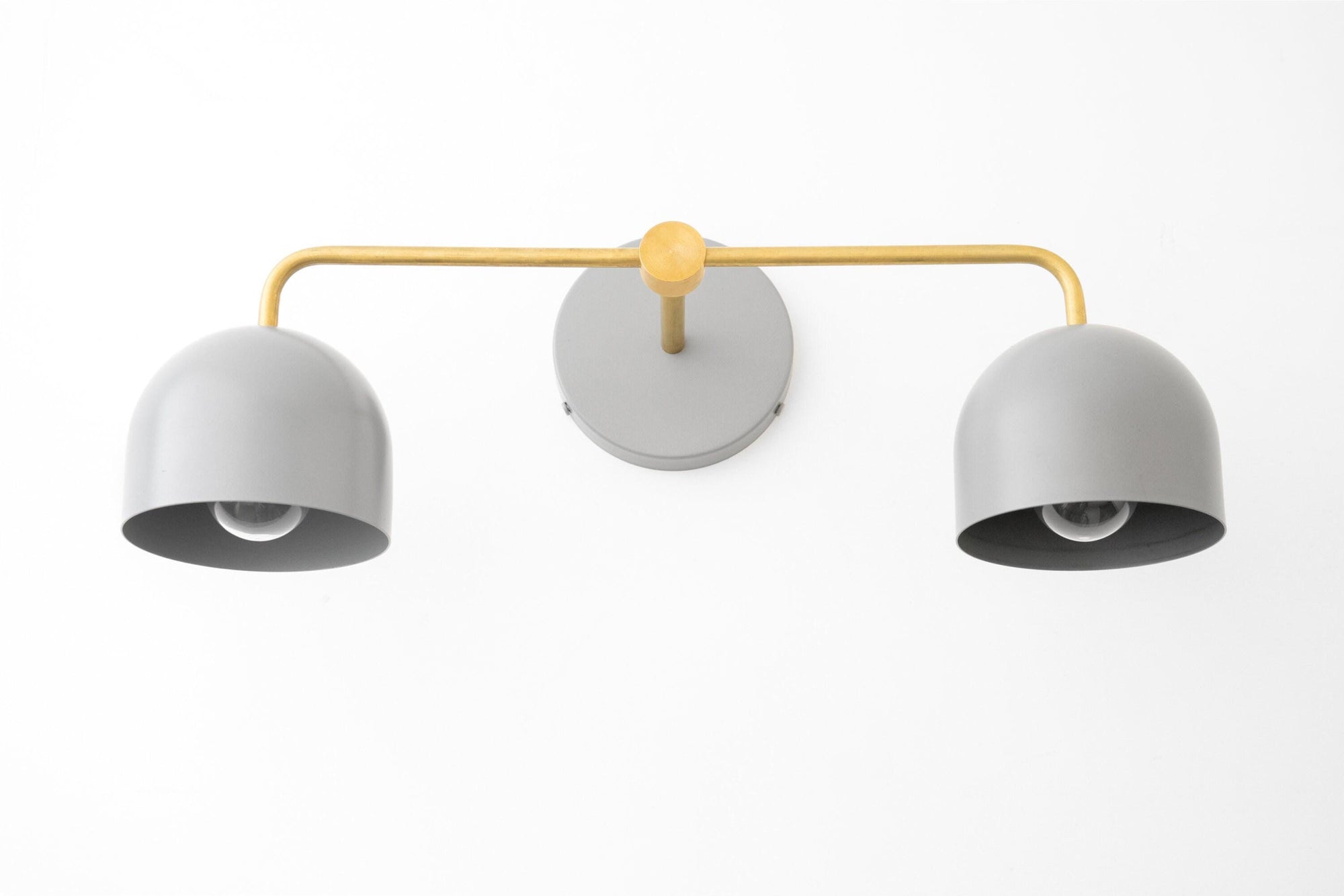 Mid-century modern vanity light with matte gray dome shades and raw brass horizontal arm and wall mount. - VANITY LIGHT MODEL NO. 2082